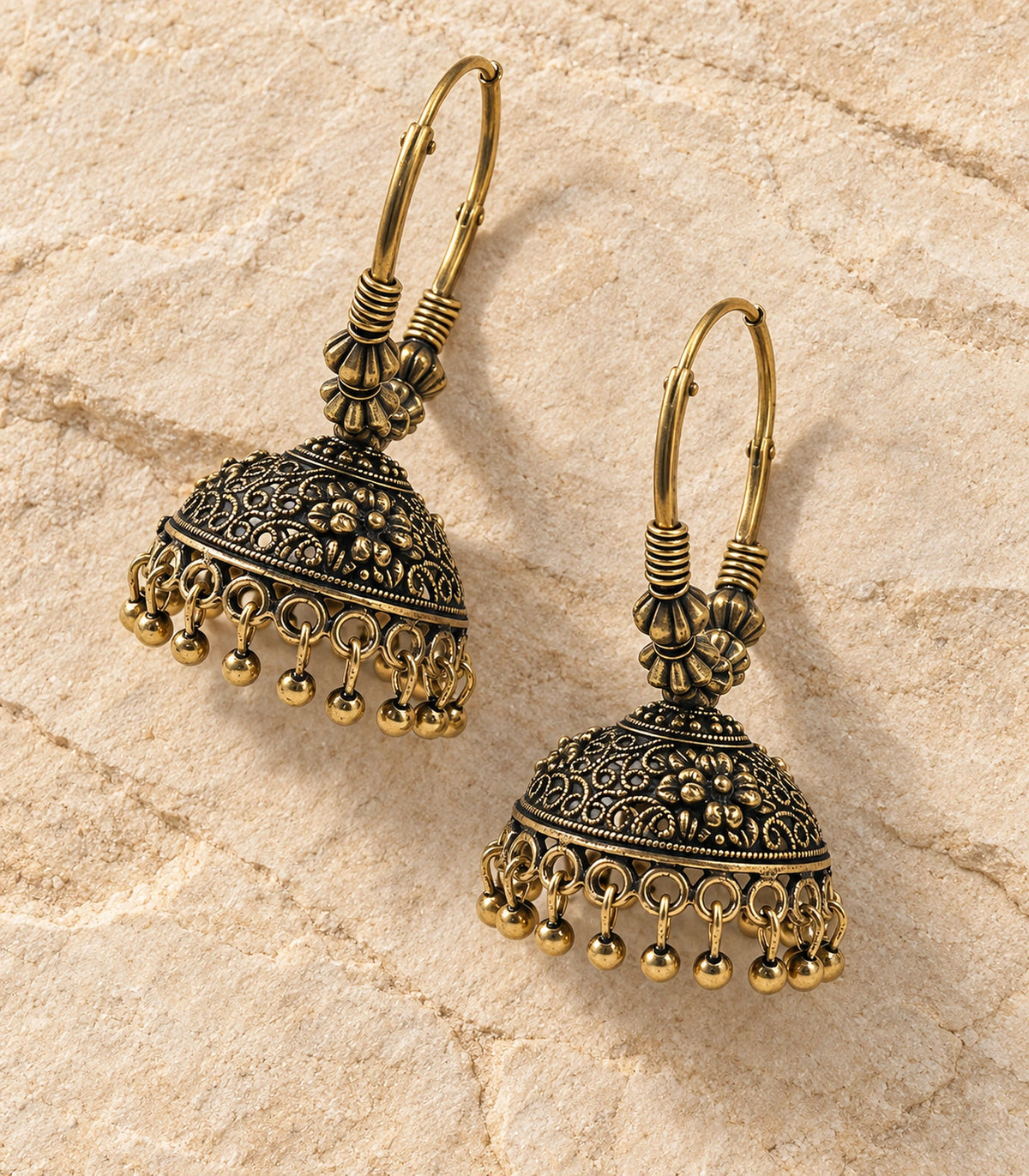 JIMIKI Beaded Hoop Floral Jhumka Earrings - Antique Gold pair in a styled flatlay #color_antique-gold