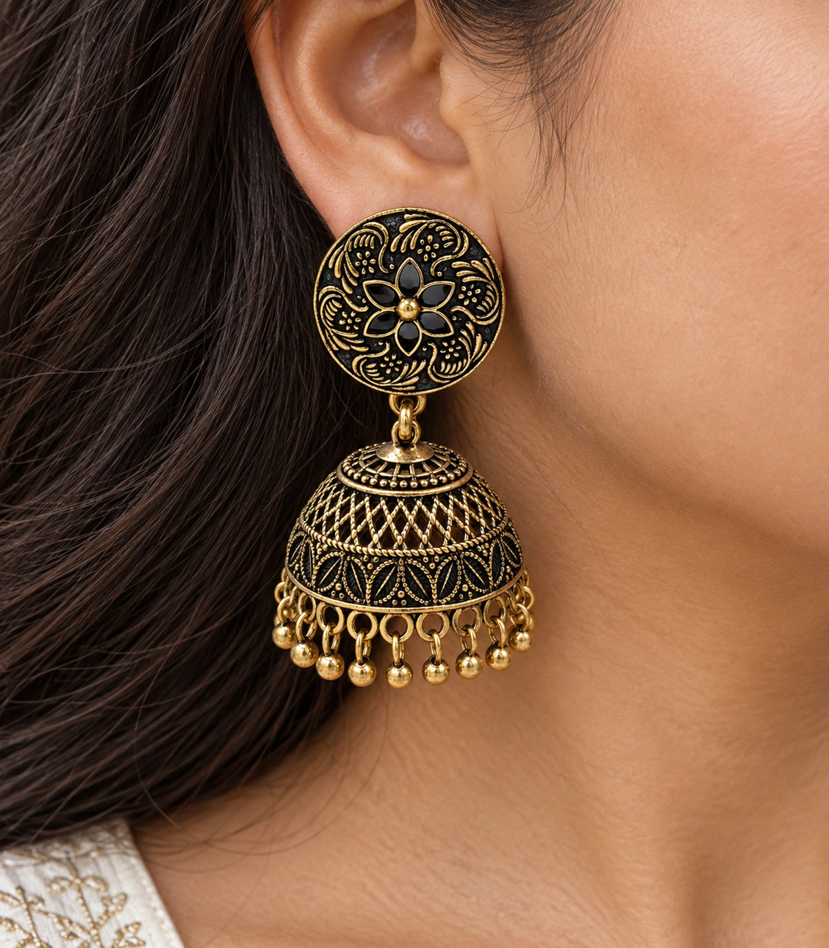 JIMIKI Antique Gold Black Floral Disc Jhumka Earrings - close-up of floral stud and patterned bell #color_antique-gold-black
