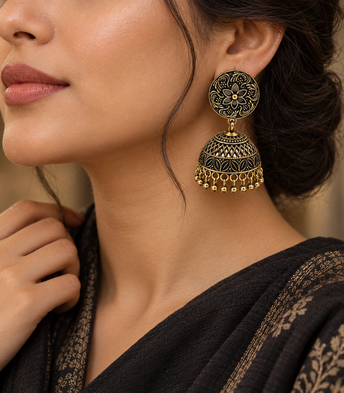 JIMIKI Antique Gold Black Floral Disc Jhumka Earrings - editorial styling with black and gold fabric #color_antique-gold-black