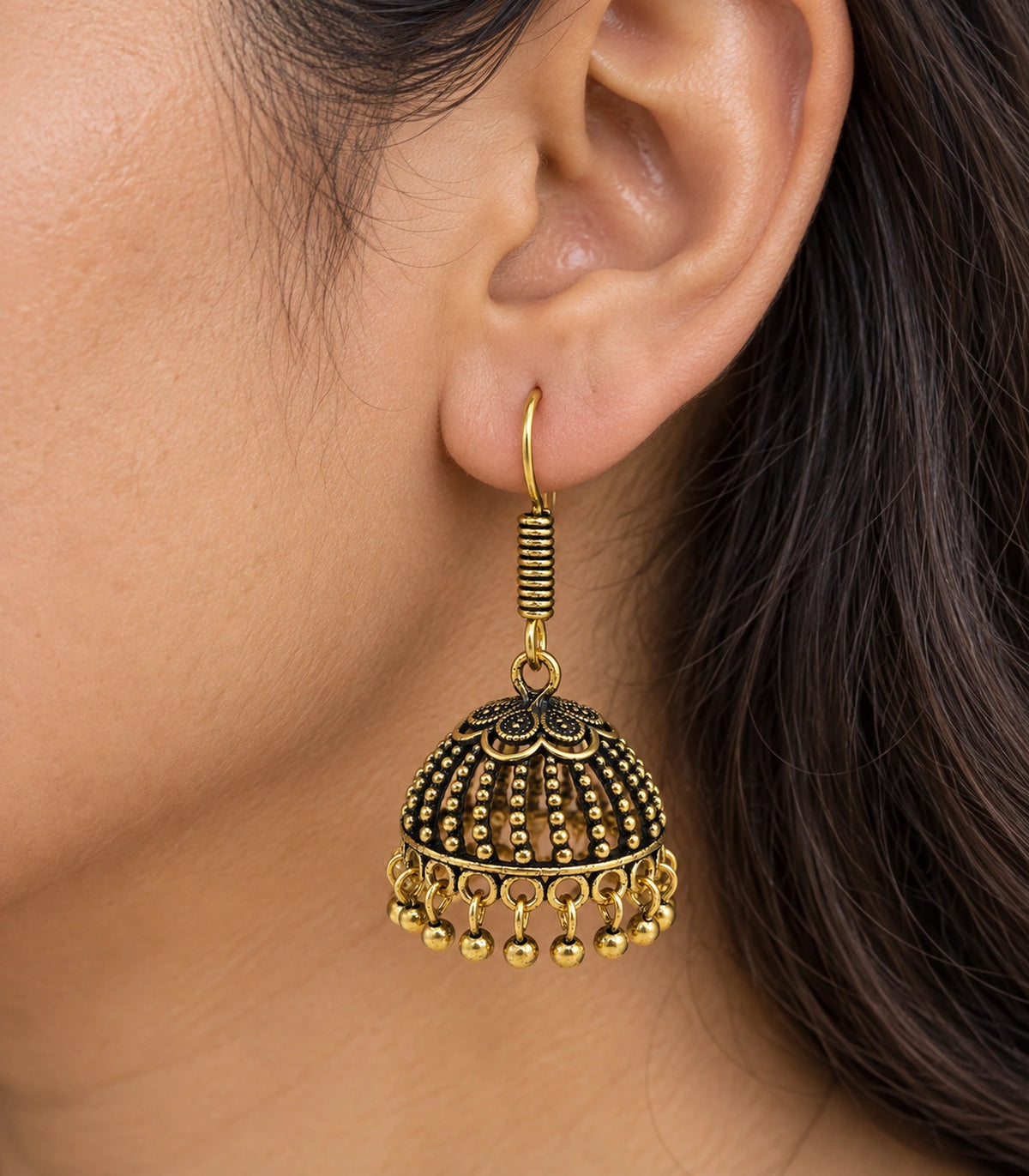 JIMIKI Antique Gold Floral Cap Beaded Dome Jhumka Earrings - close-up of the earring worn #color_antique-gold