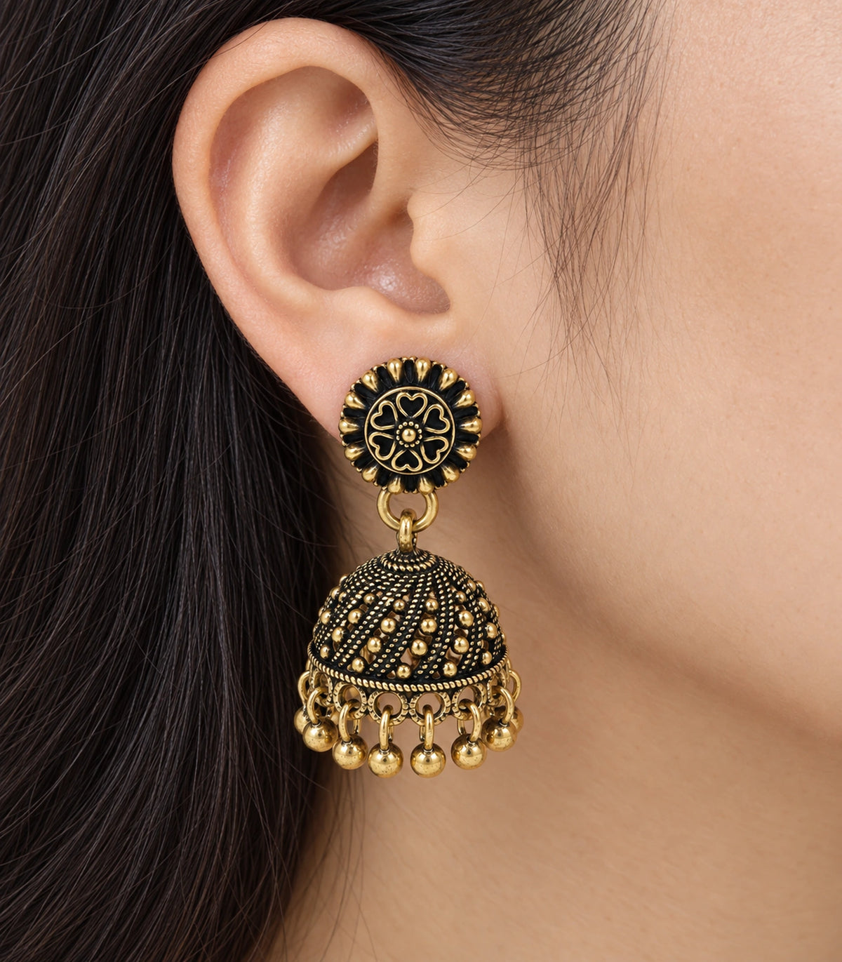 JIMIKI Antique Gold Floral Rosette Jhumka Earrings - Worn close-up of floral rosette and textured bell #color_antique-gold