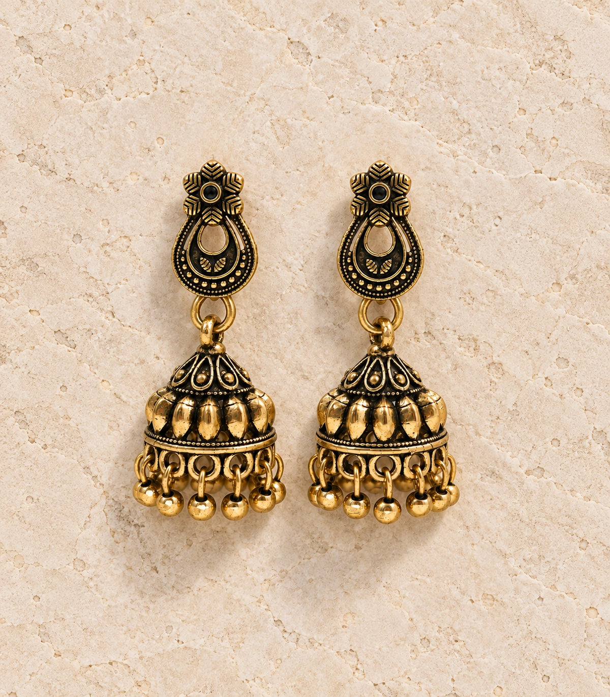 JIMIKI Antique Gold Floral Teardrop Leaf Jhumka Earrings in Antique Gold - editorial flatlay #color_antique-gold