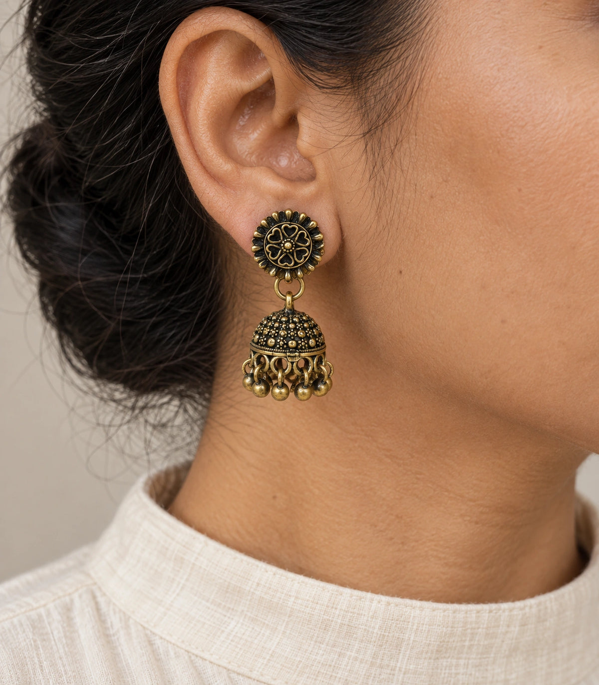 JIMIKI Antique Gold Heart Flower Stud Dotted Jhumka Earrings in Antique Gold - worn styling view #color_antique-gold