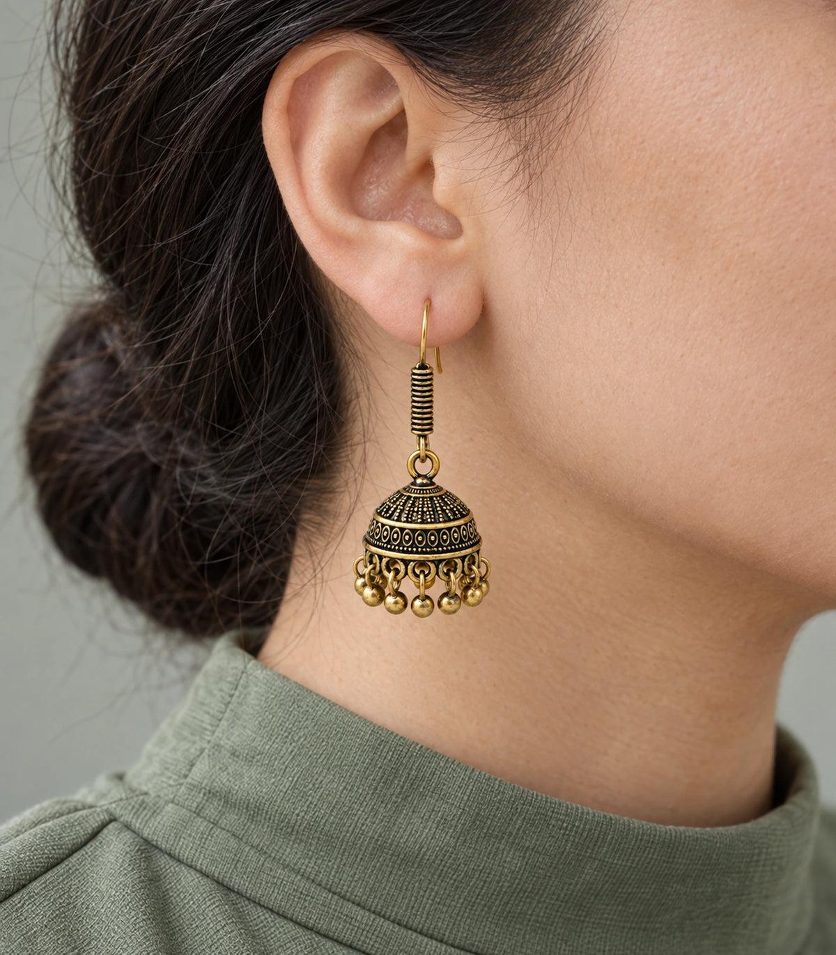JIMIKI Antique Gold Oval Band Jhumka Earrings - styled model wearing the earring #color_antique-gold