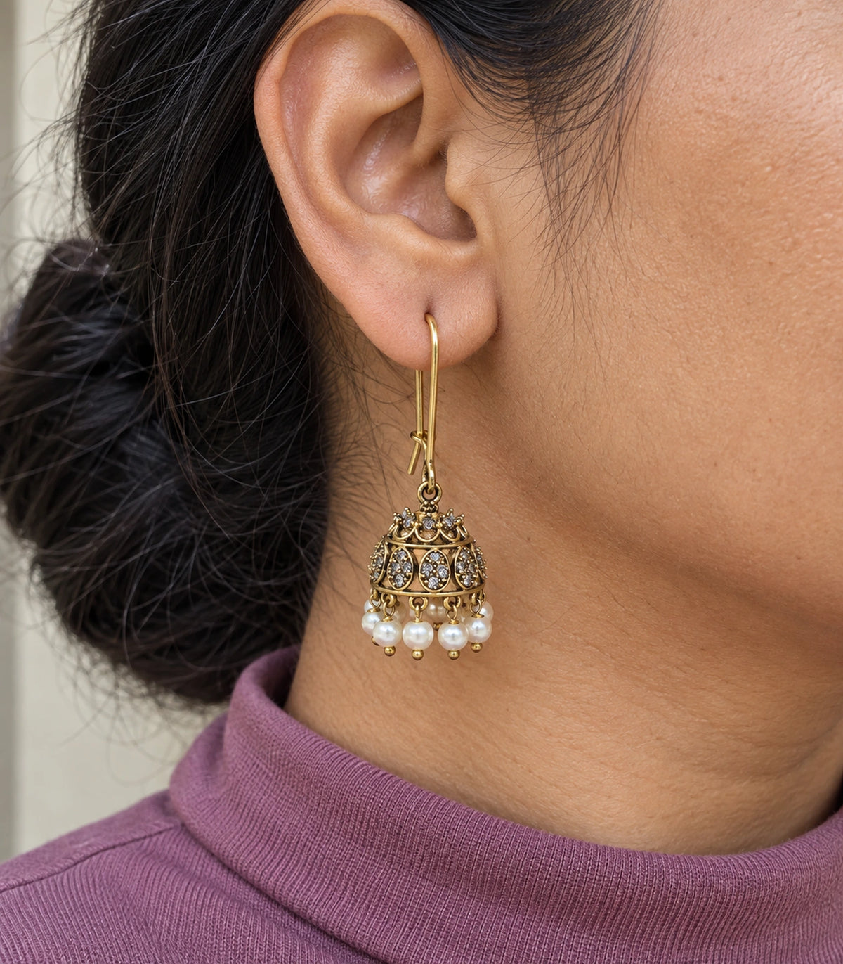 JIMIKI Antique Gold Oval Crystal Pearl Kidney Wire Jhumka Earrings - Close-up of the earring details #color_antique-gold