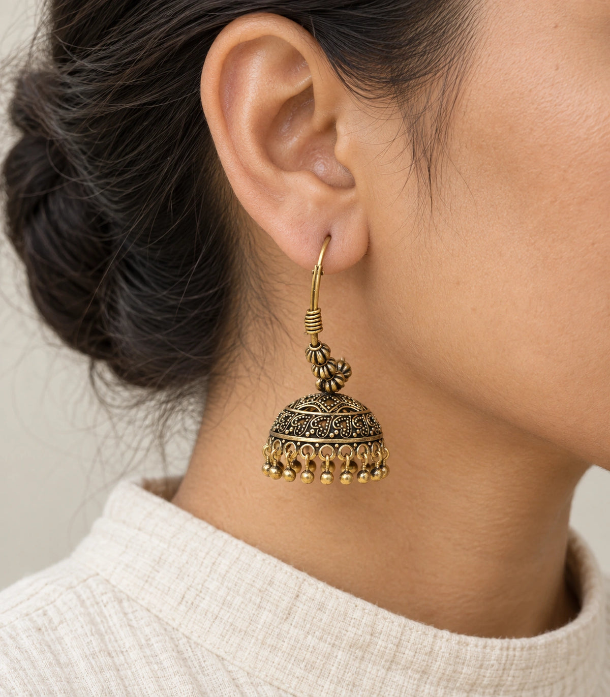 JIMIKI Paisley Beaded Hoop Jhumka Earrings in Antique Gold - worn styling view #color_antique-gold