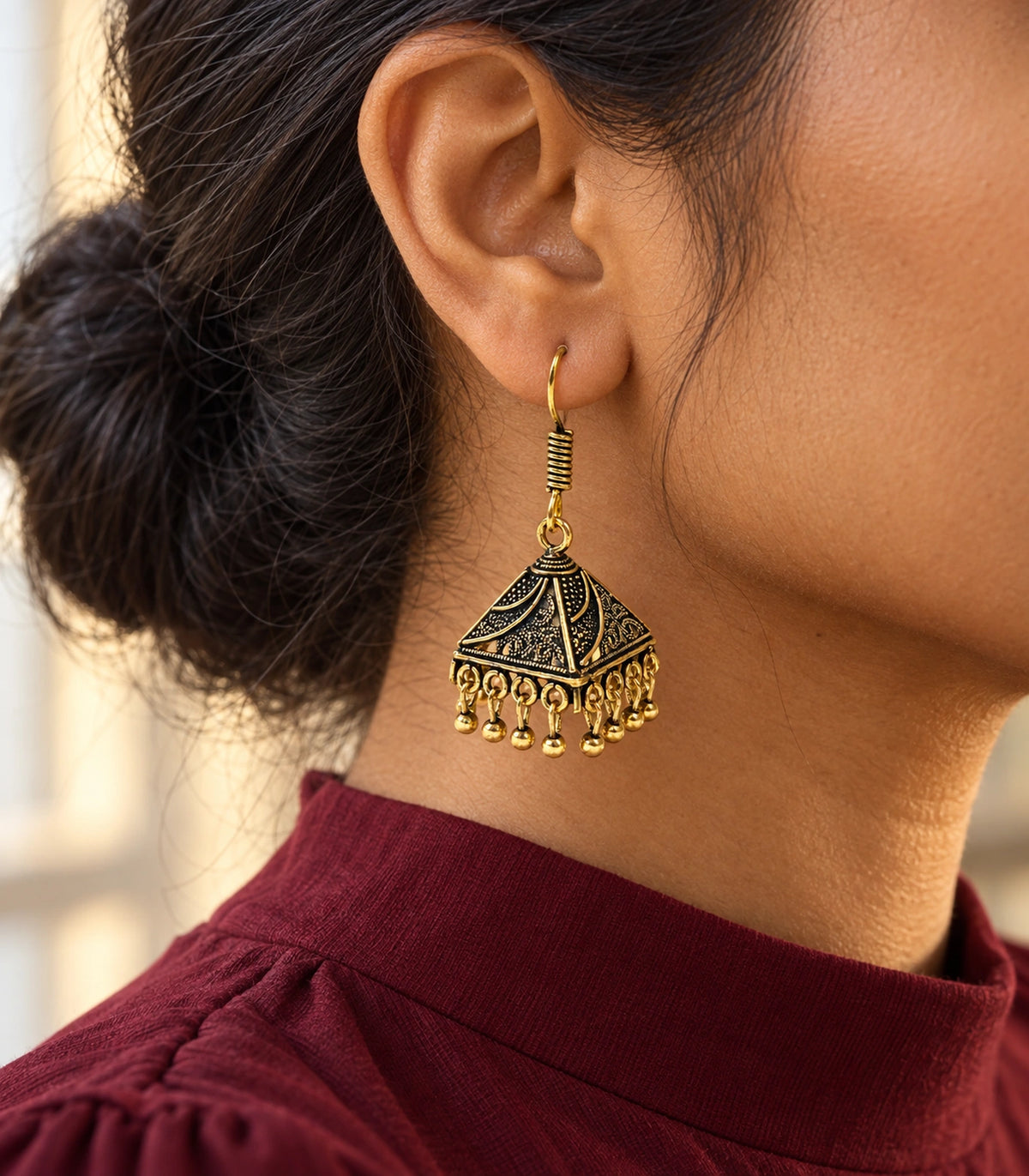 JIMIKI Antique Gold Paisley Pyramid Jhumka Earrings - styled model wearing the earring #color_antique-gold