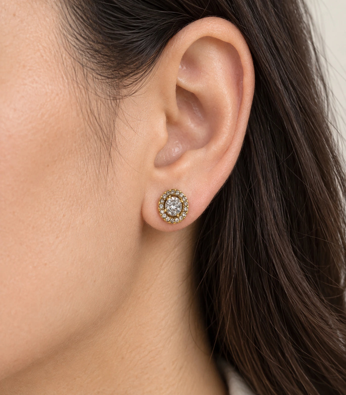 JIMIKI Antique Gold Round Crystal Halo Stud Earrings, worn close-up showing clear accents and gold-tone setting #color_antique gold