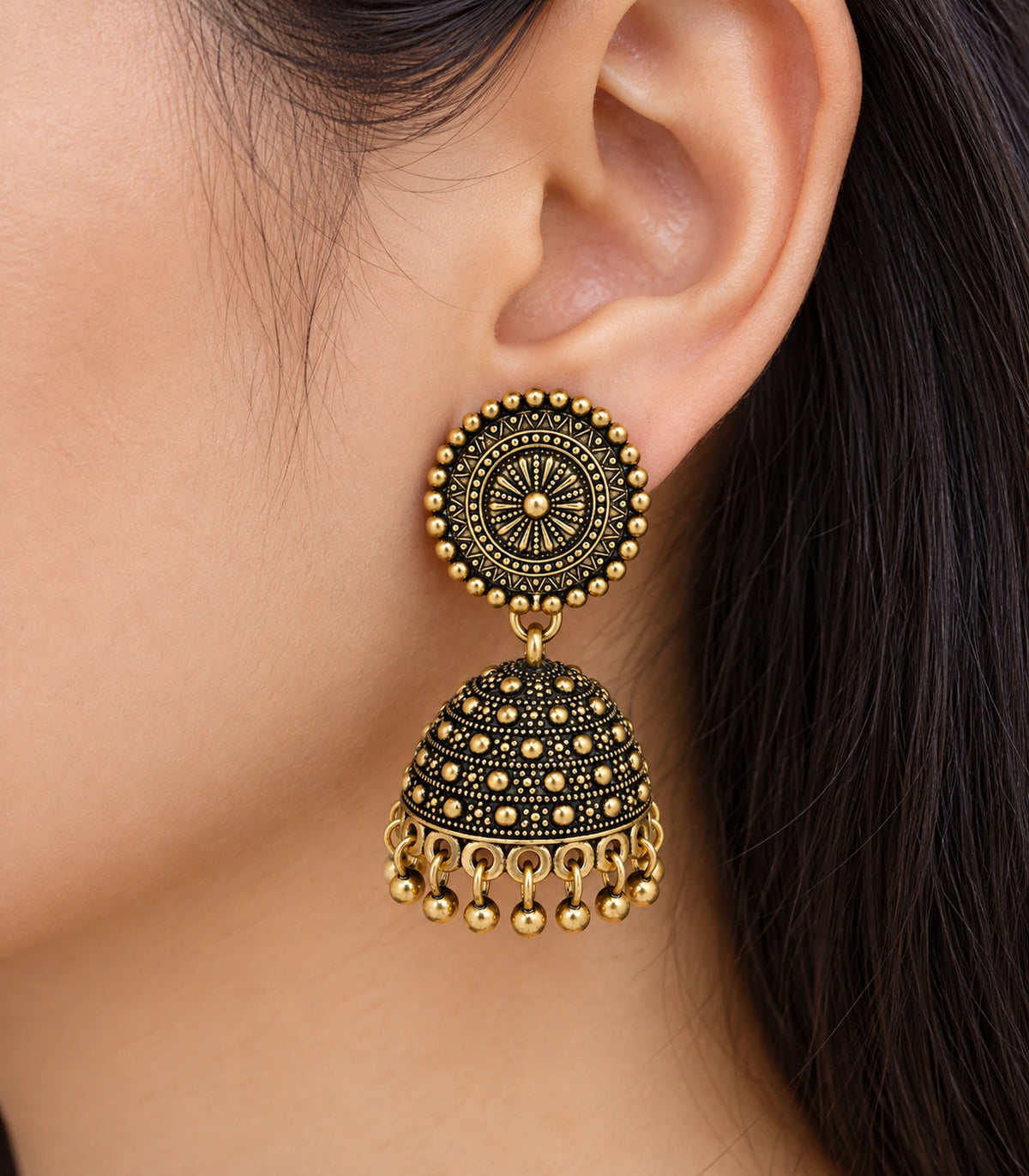 JIMIKI Antique Gold Sunburst Medallion Jhumka Earrings - Worn close-up of sunburst stud and dotted dome #color_antique-gold