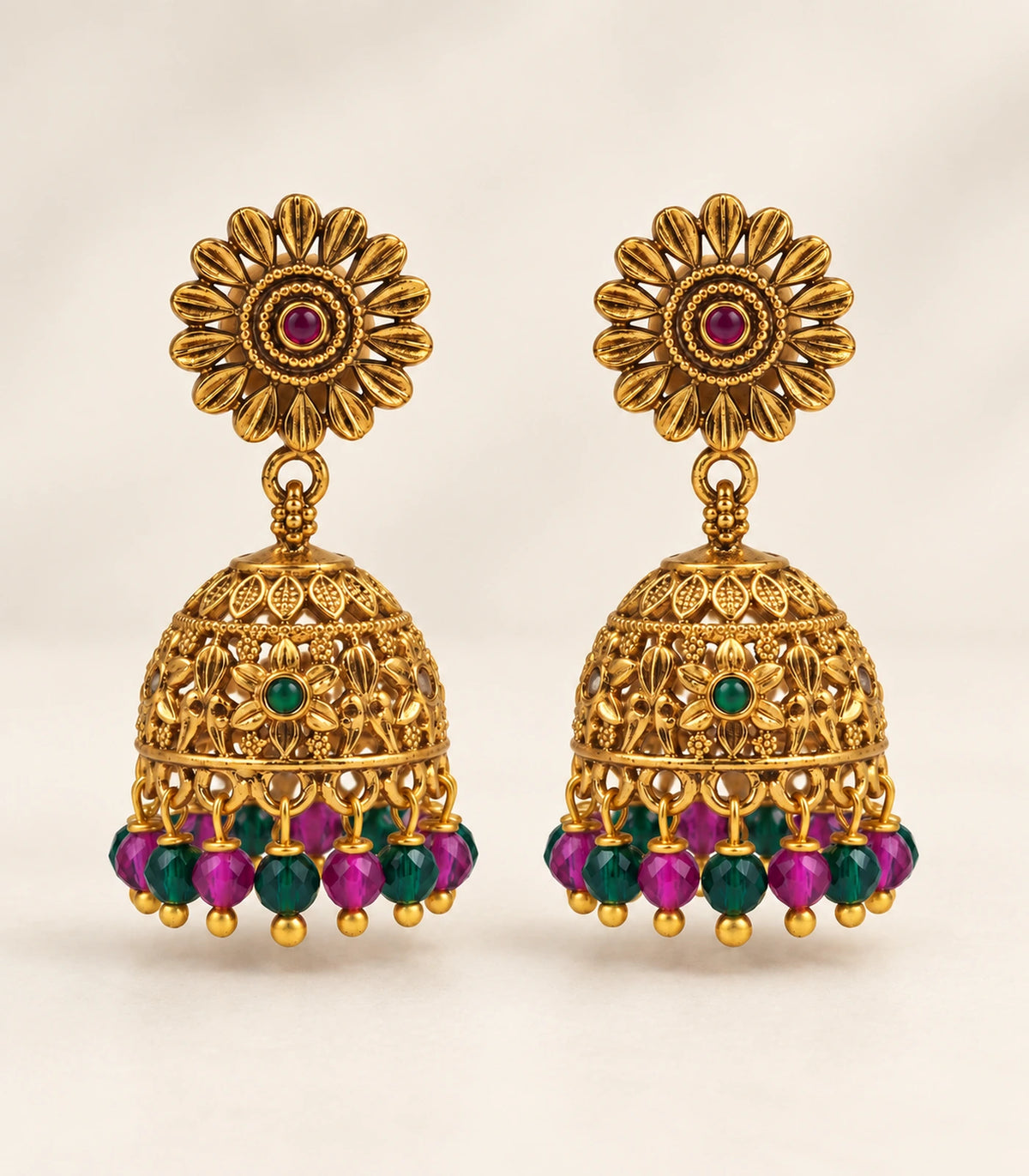Antique gold-tone sunflower multicolour bead jhumka earrings, editorial flatlay view