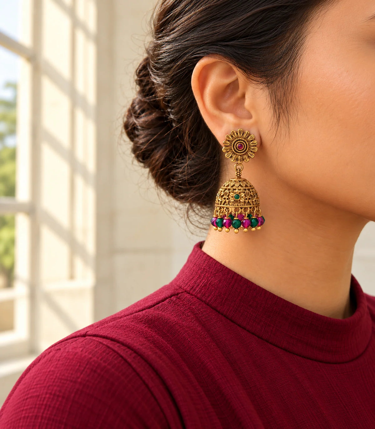 Antique gold-tone sunflower multicolour bead jhumka earrings, editorial model view