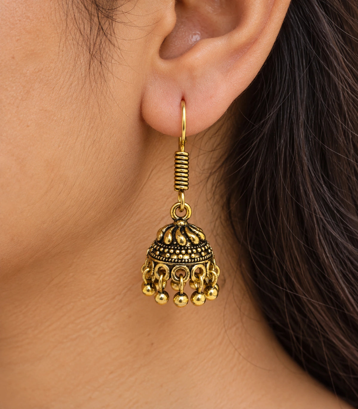 JIMIKI Antique Gold Swirl Crown Jhumka Earrings - close-up of the earring worn #color_antique-gold