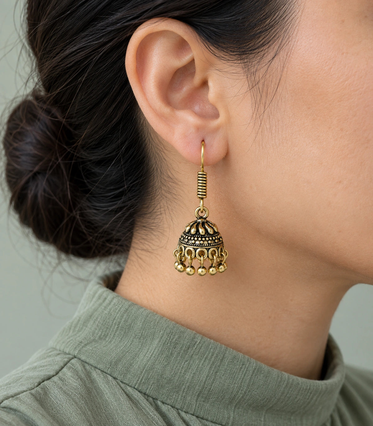 JIMIKI Antique Gold Swirl Crown Jhumka Earrings - styled model wearing the earring #color_antique-gold