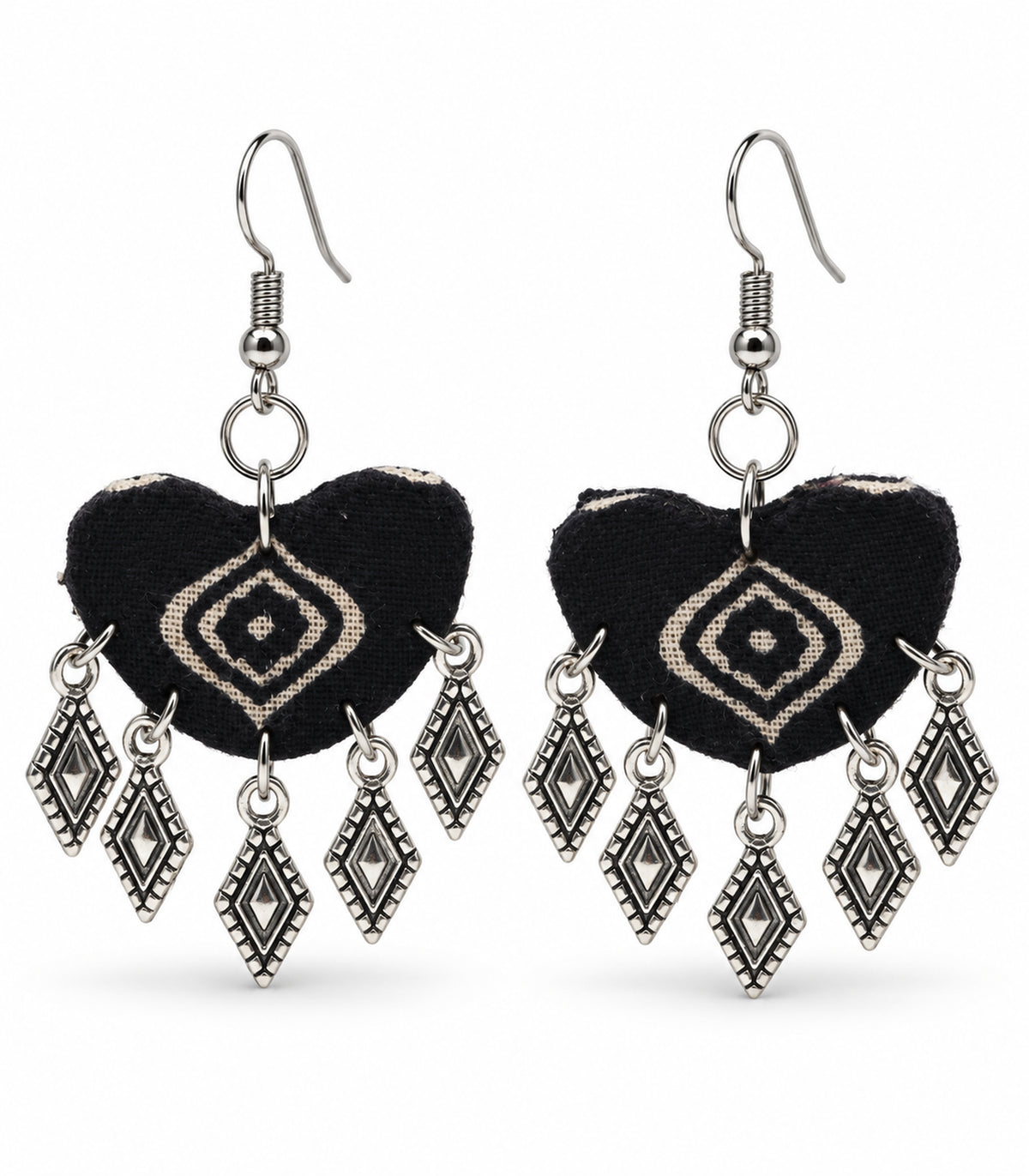 Complete pair of black and cream diamond-print fabric earrings with silver-tone dangling charms on white