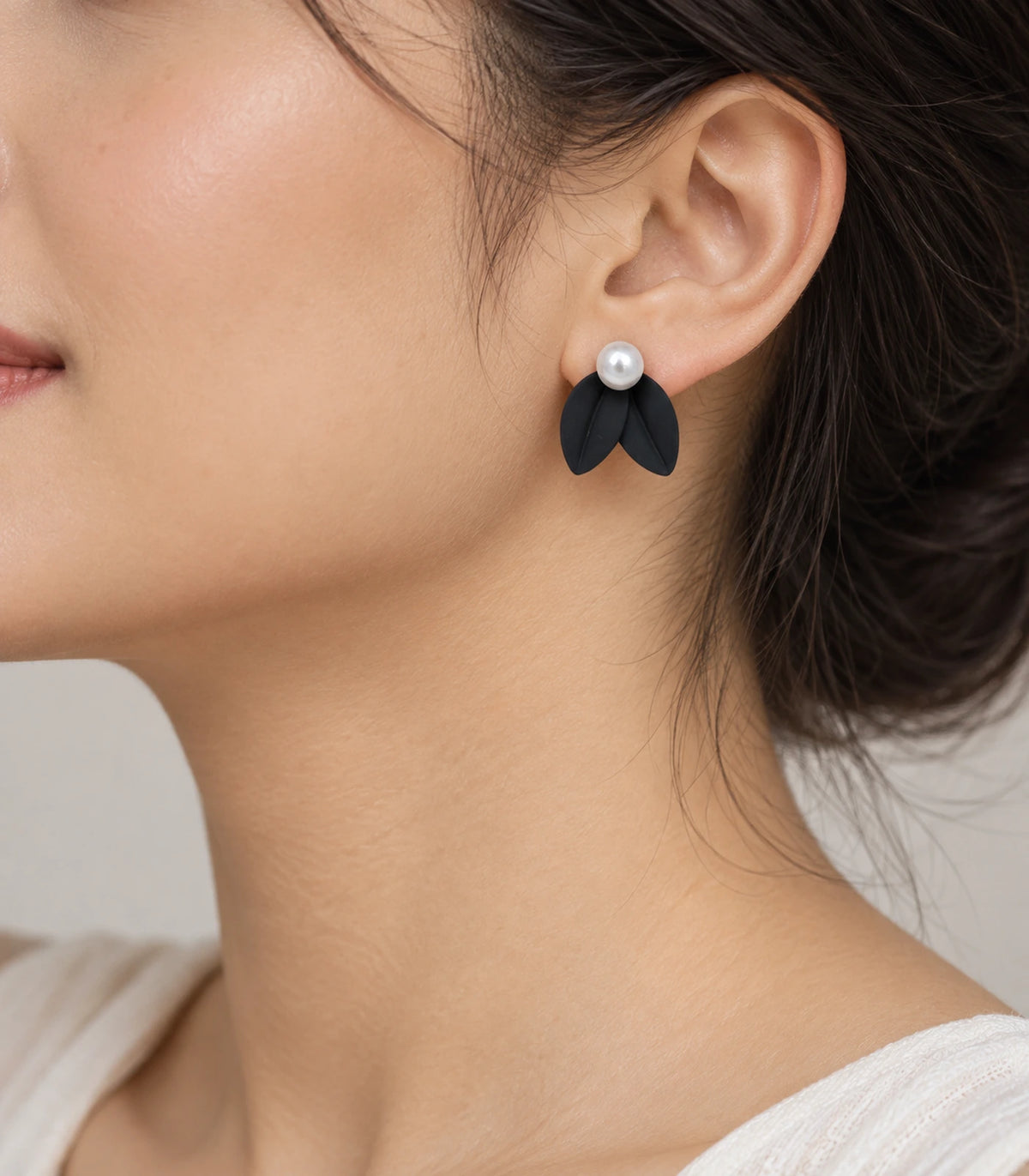 JIMIKI Double Leaf Pearl Stud Earrings in Black — earrings worn on the ear #color_black