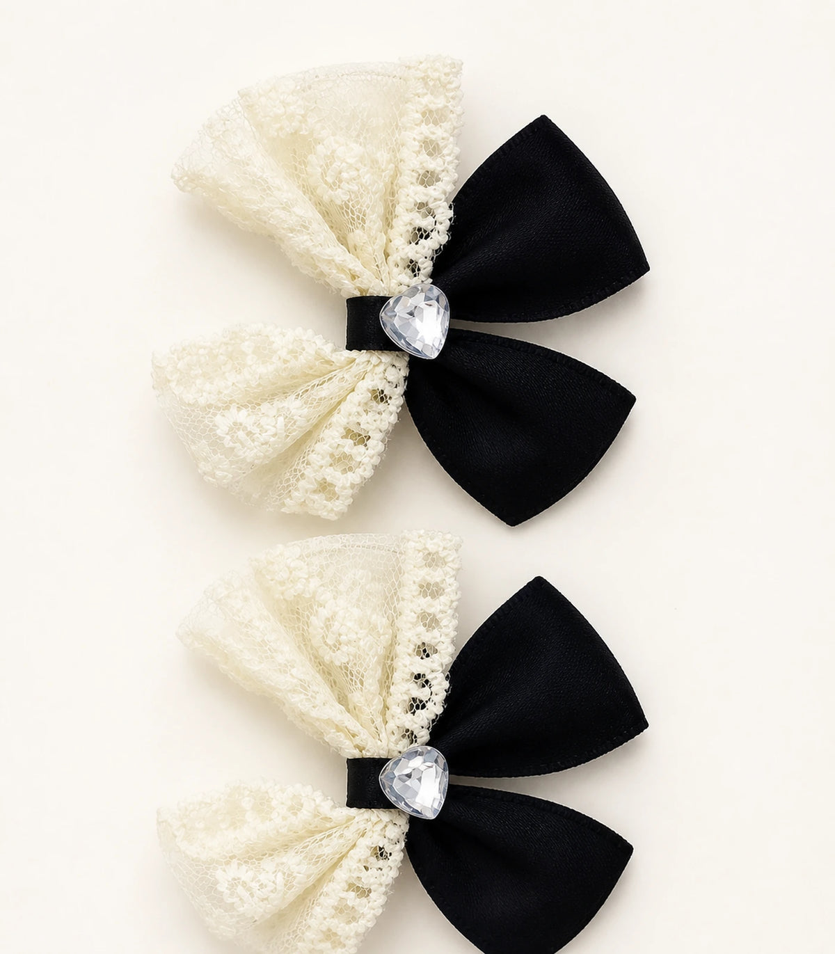 Close-up of the Black Ivory Lace Heart Bow Clip Pair details