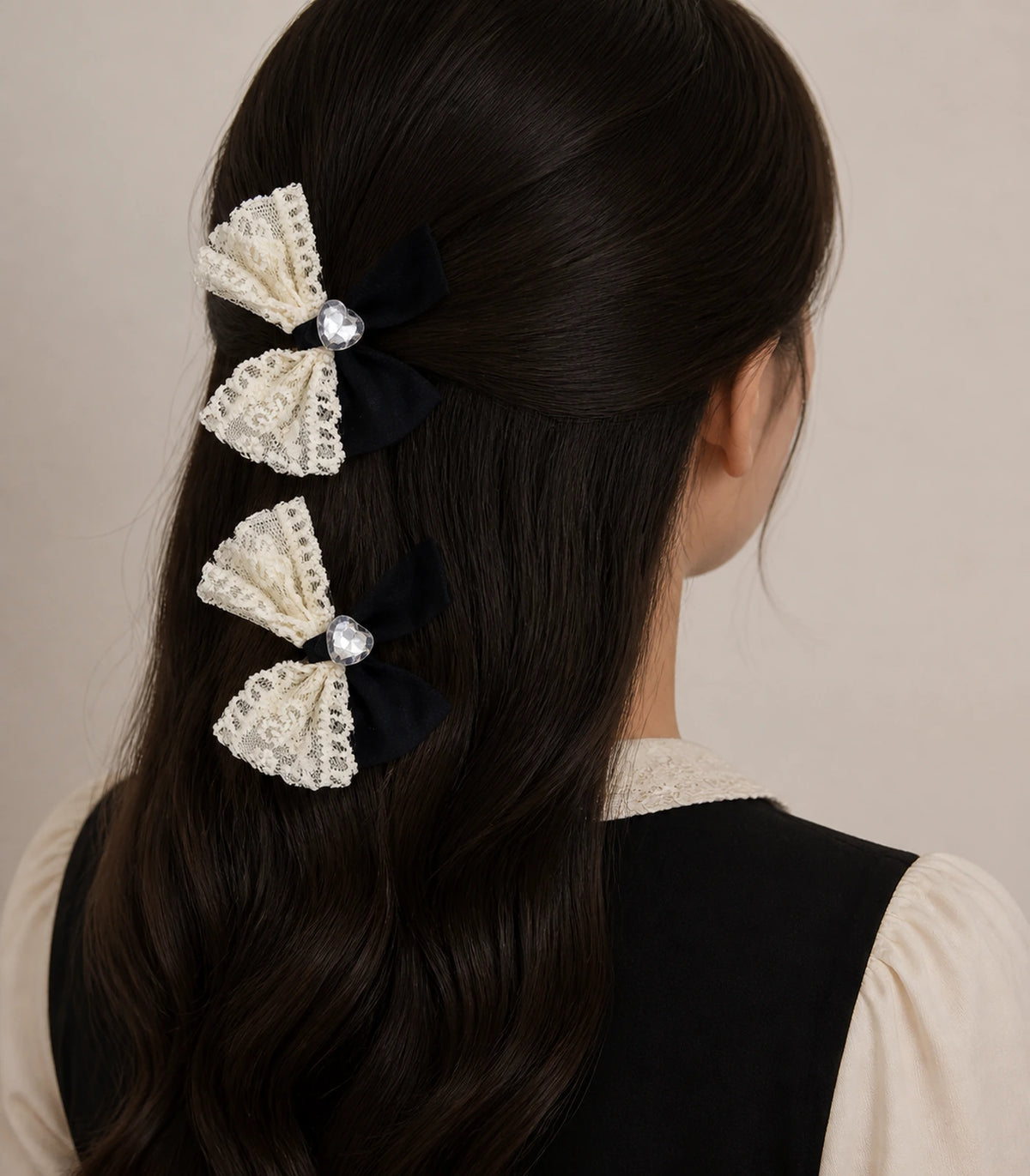 Editorial model view of the Black Ivory Lace Heart Bow Clip Pair