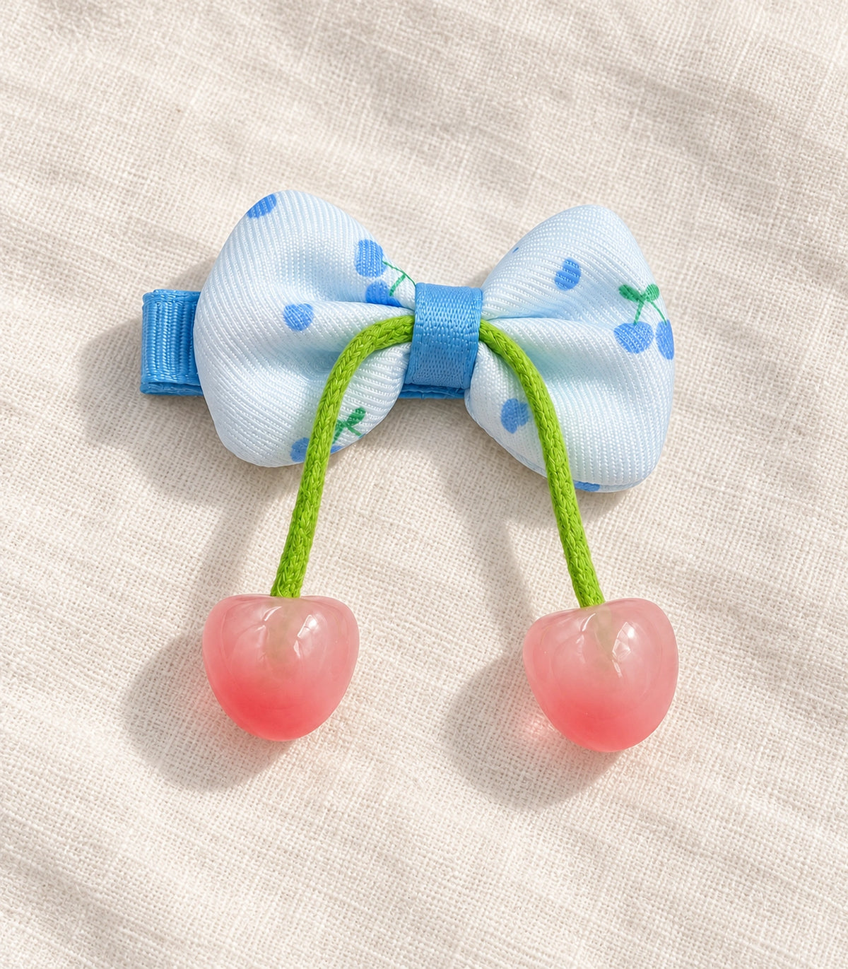 JIMIKI Cherry Print Bow Hair Clip With Cherry Charms in Blue, editorial flat lay #color_blue