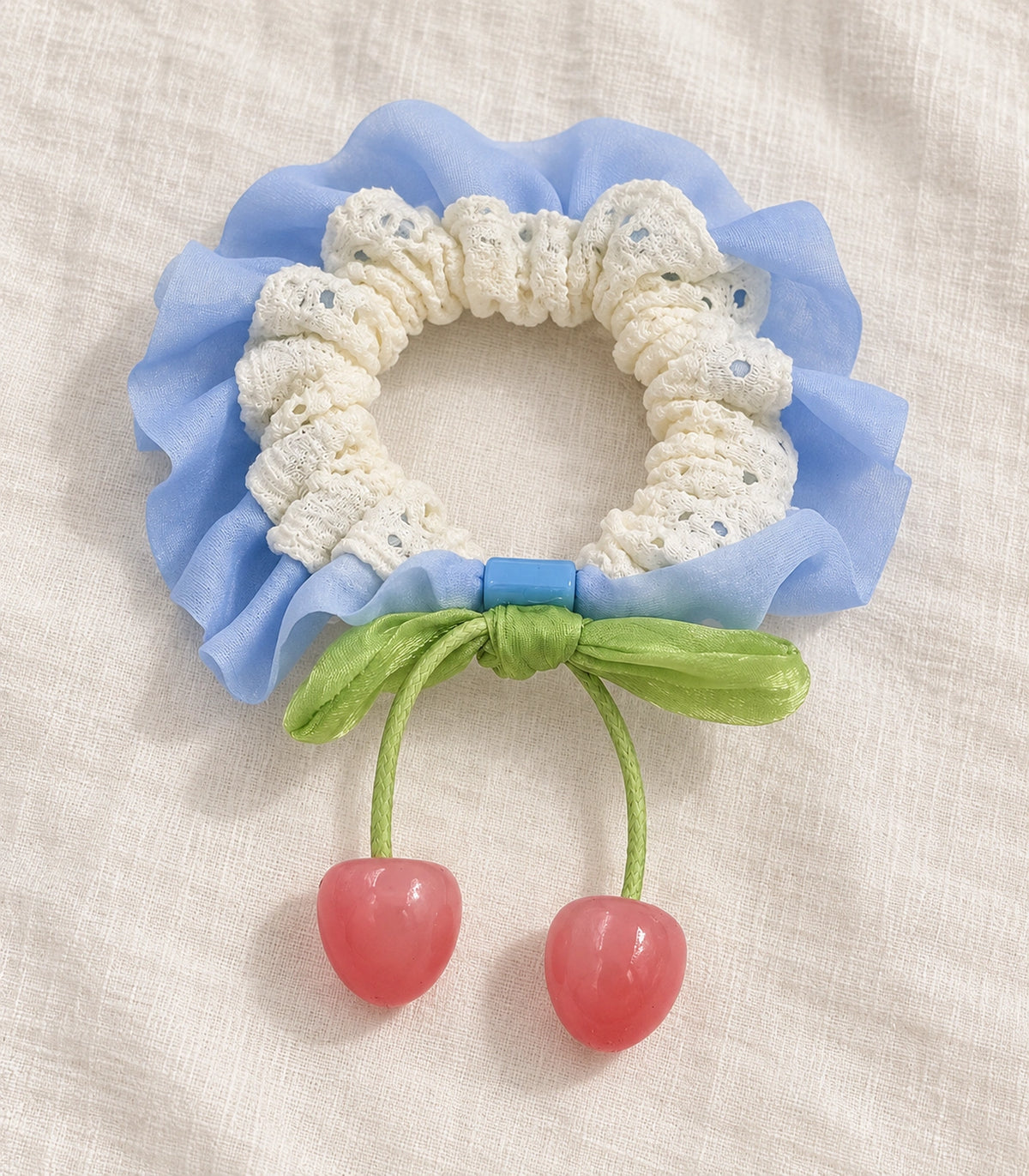 JIMIKI Lace Scrunchie With Cherry Charms in Blue, editorial flat lay #color_blue