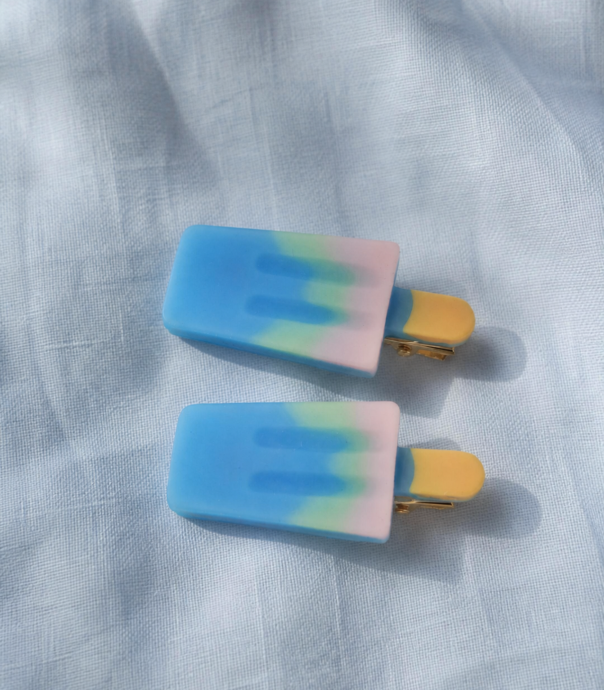 Blue Pink Popsicle Clip Pair in an editorial flat lay