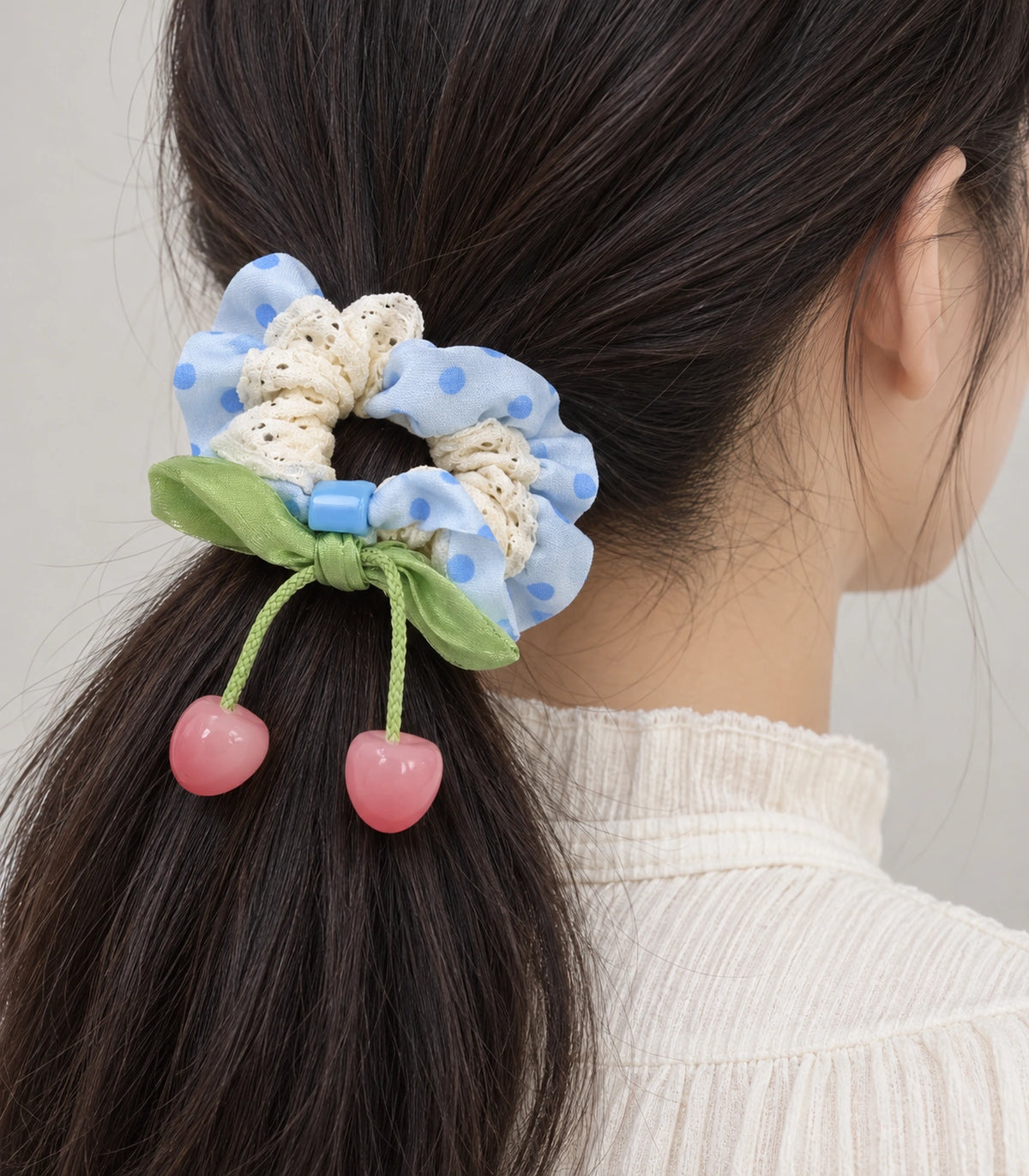 JIMIKI Polka Dot Lace Scrunchie With Cherry Charms in Blue, close-up detail #color_blue