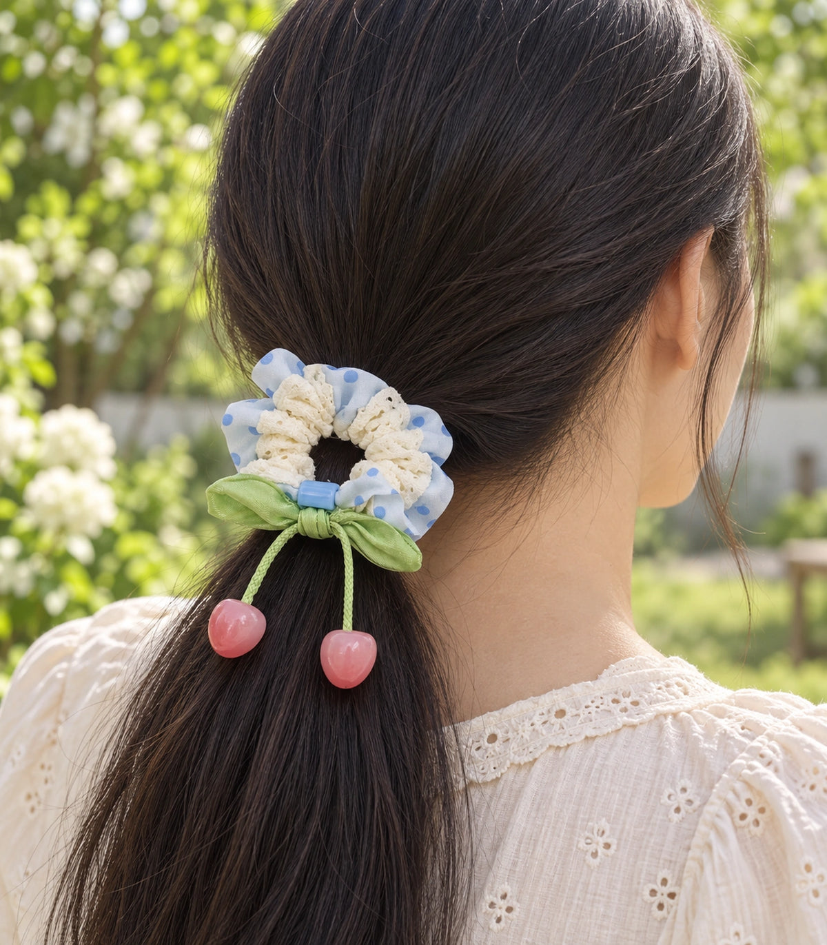 JIMIKI Polka Dot Lace Scrunchie With Cherry Charms in Blue, editorial model view #color_blue