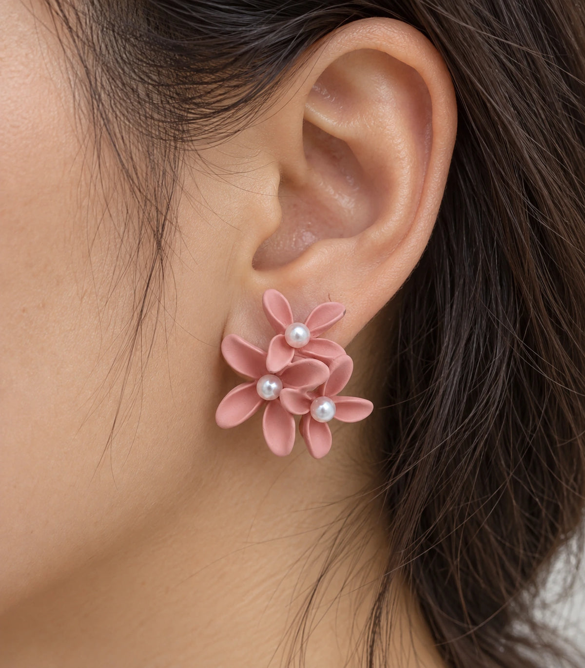 JIMIKI Blush Pink cascading floral cluster stud earrings, close-up of the three pearl-like centres and curved petals #color_blush pink