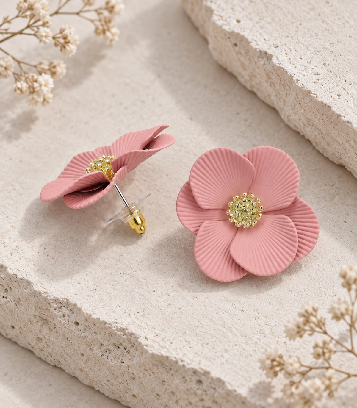 JIMIKI Blush Pink ribbed flower stud earrings, pair arranged in an editorial flat lay #color_blush pink