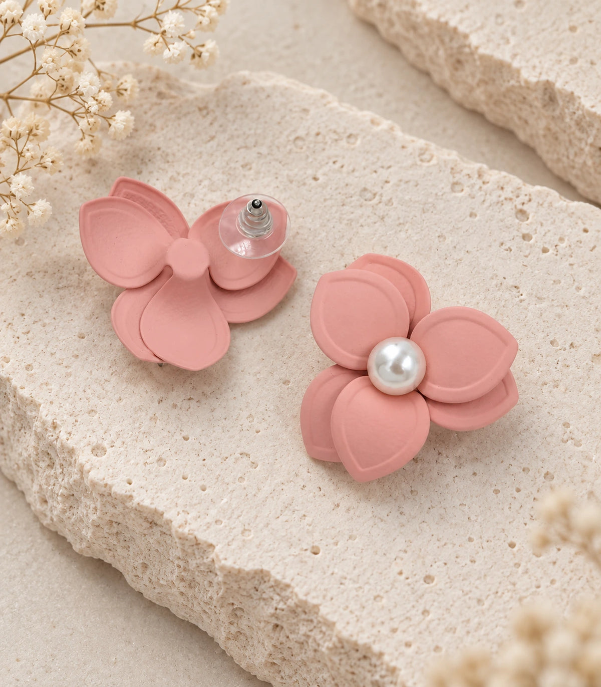 JIMIKI Blush Pink Triple Petal Pearl Flower Stud Earrings - pair in styled flat lay #color_blush pink