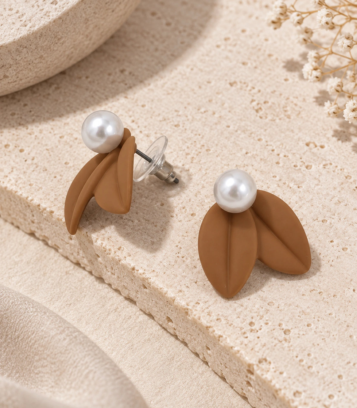 JIMIKI Double Leaf Pearl Stud Earrings in Camel — pair in a styled flat lay #color_camel