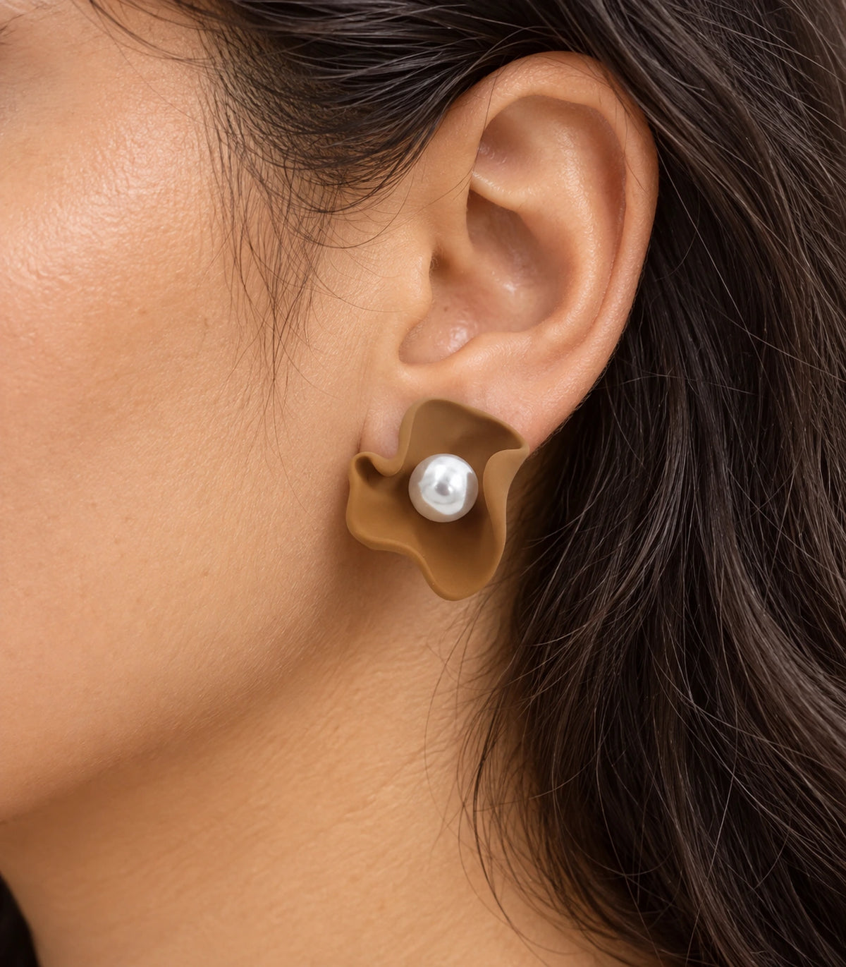 JIMIKI Folded Calla Pearl Stud Earrings, Camel — worn close-up showing petal detail #color_camel