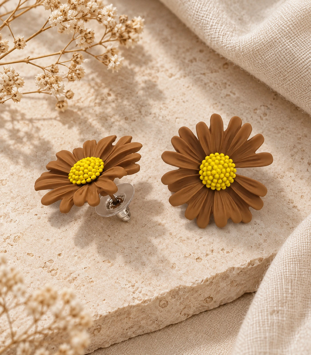 JIMIKI Camel yellow centre daisy stud earrings, matching pair on a styled stone surface #color_camel
