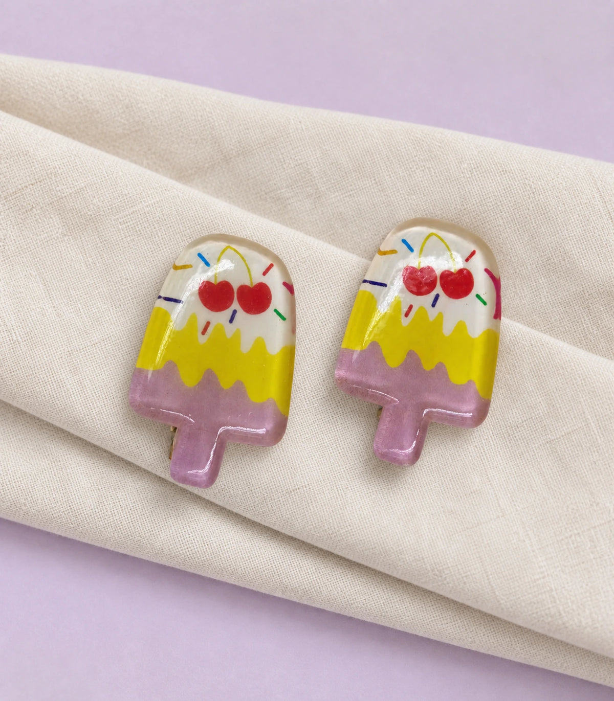 Editorial flat lay of the Cherry Sprinkle Layered Popsicle Clip Pair