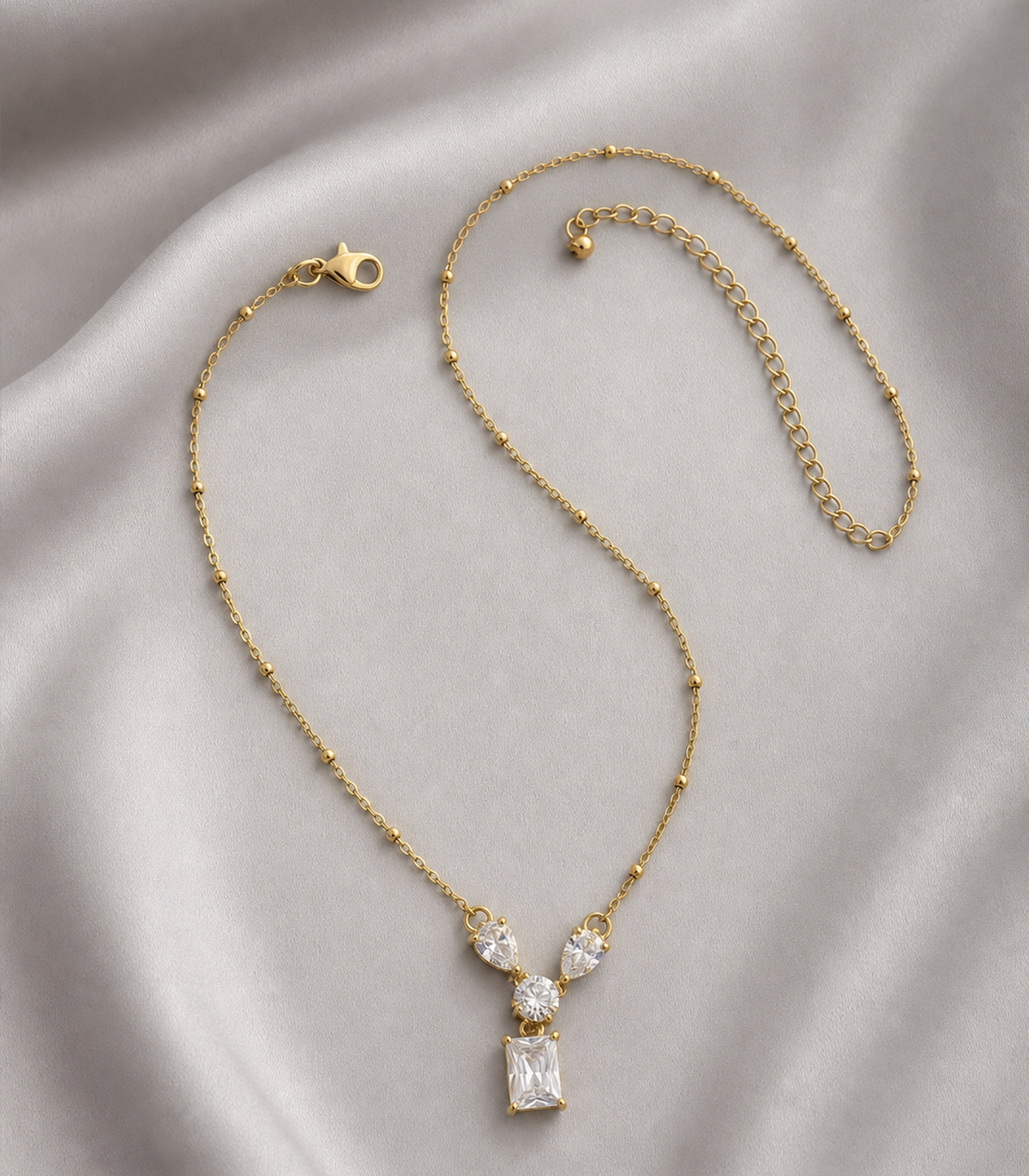 Clear Crystal Pendant Necklace in an editorial flat lay