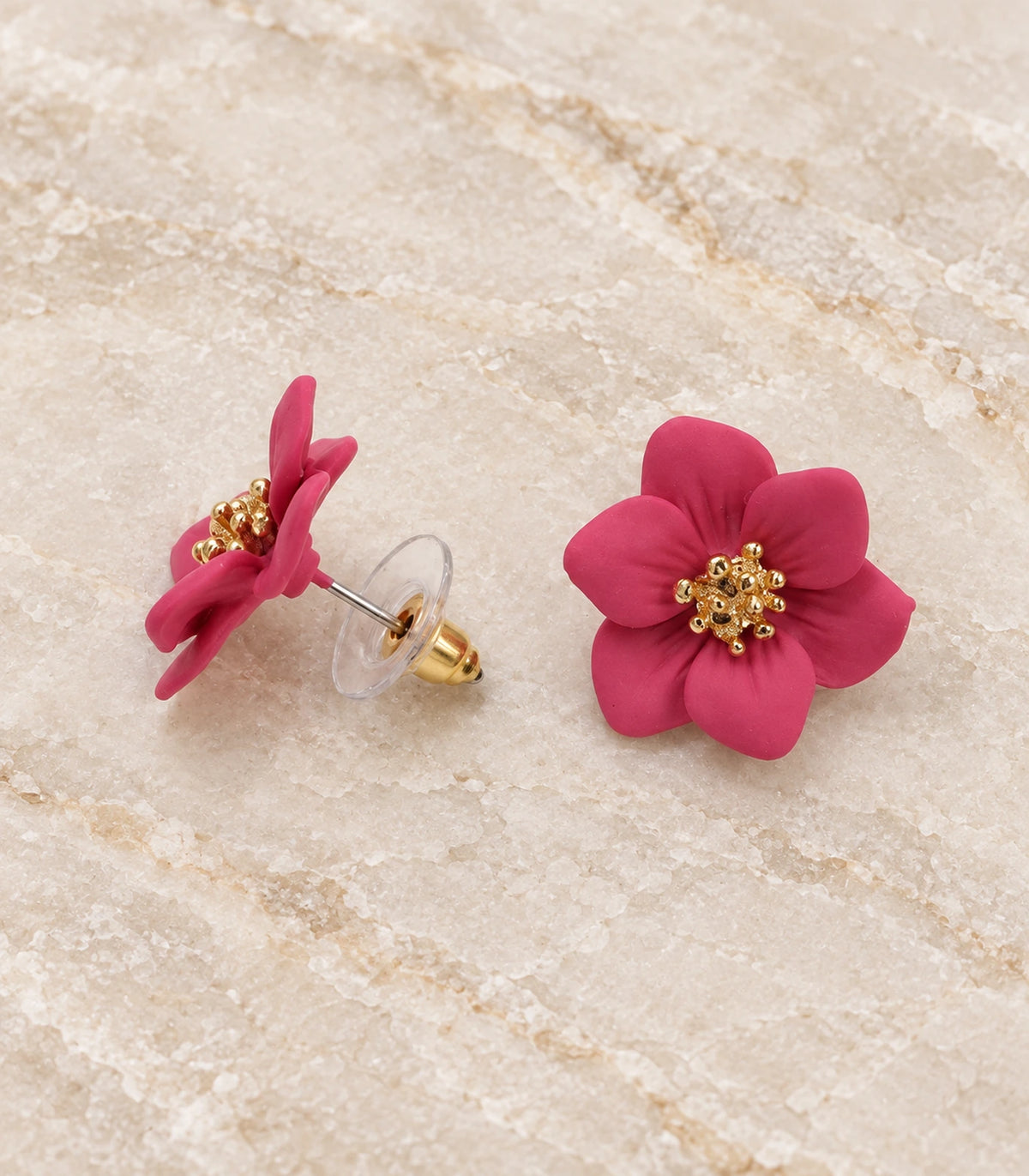 JIMIKI Deep Pink compact six petal flower stud earrings, matching pair in a styled flat lay #color_deep pink