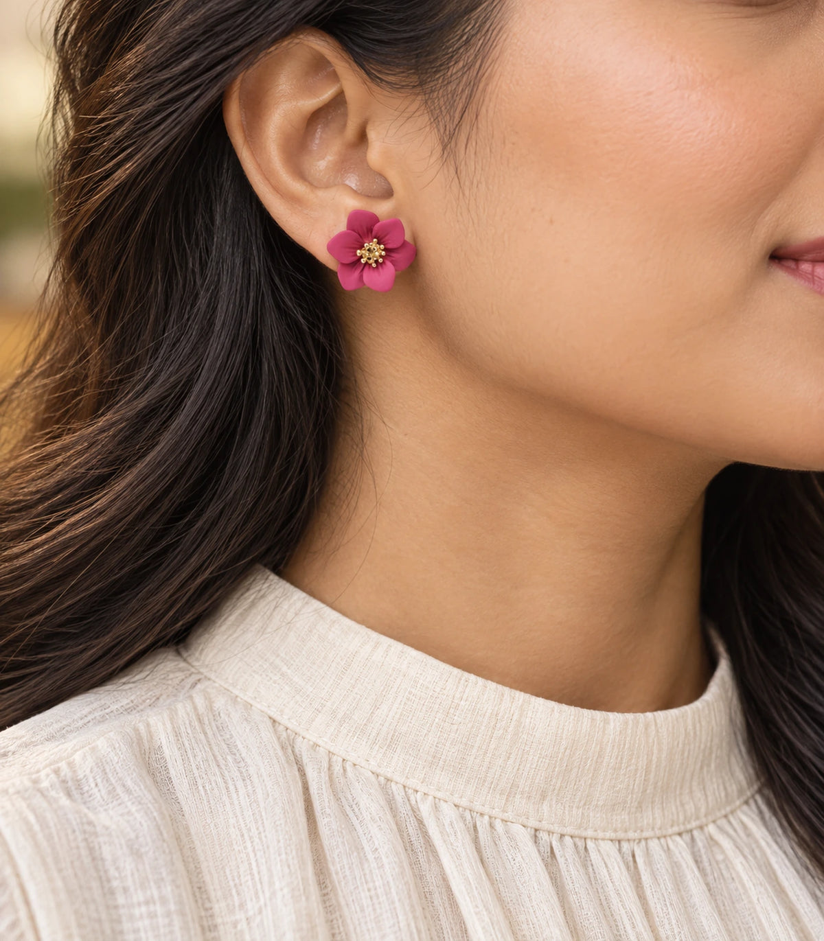 JIMIKI Deep Pink compact six petal flower stud earrings, styled portrait showing the flower stud at the ear #color_deep pink