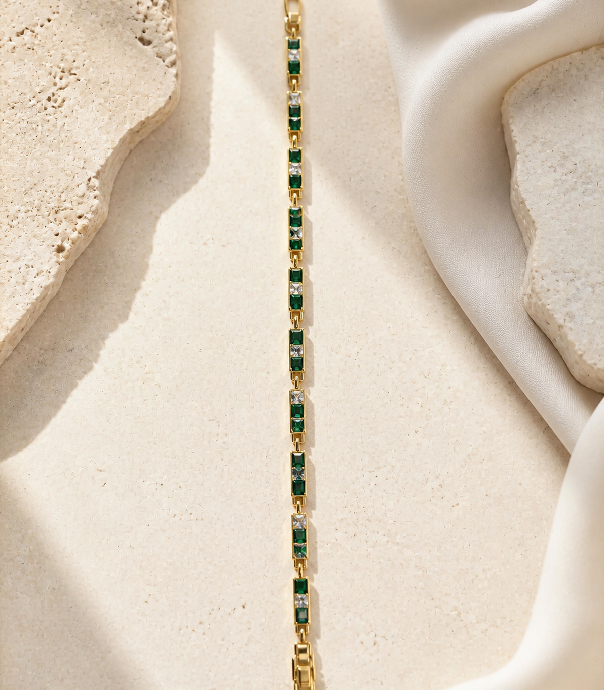 Emerald Green Baguette Crystal Link Bracelet in an editorial flat lay