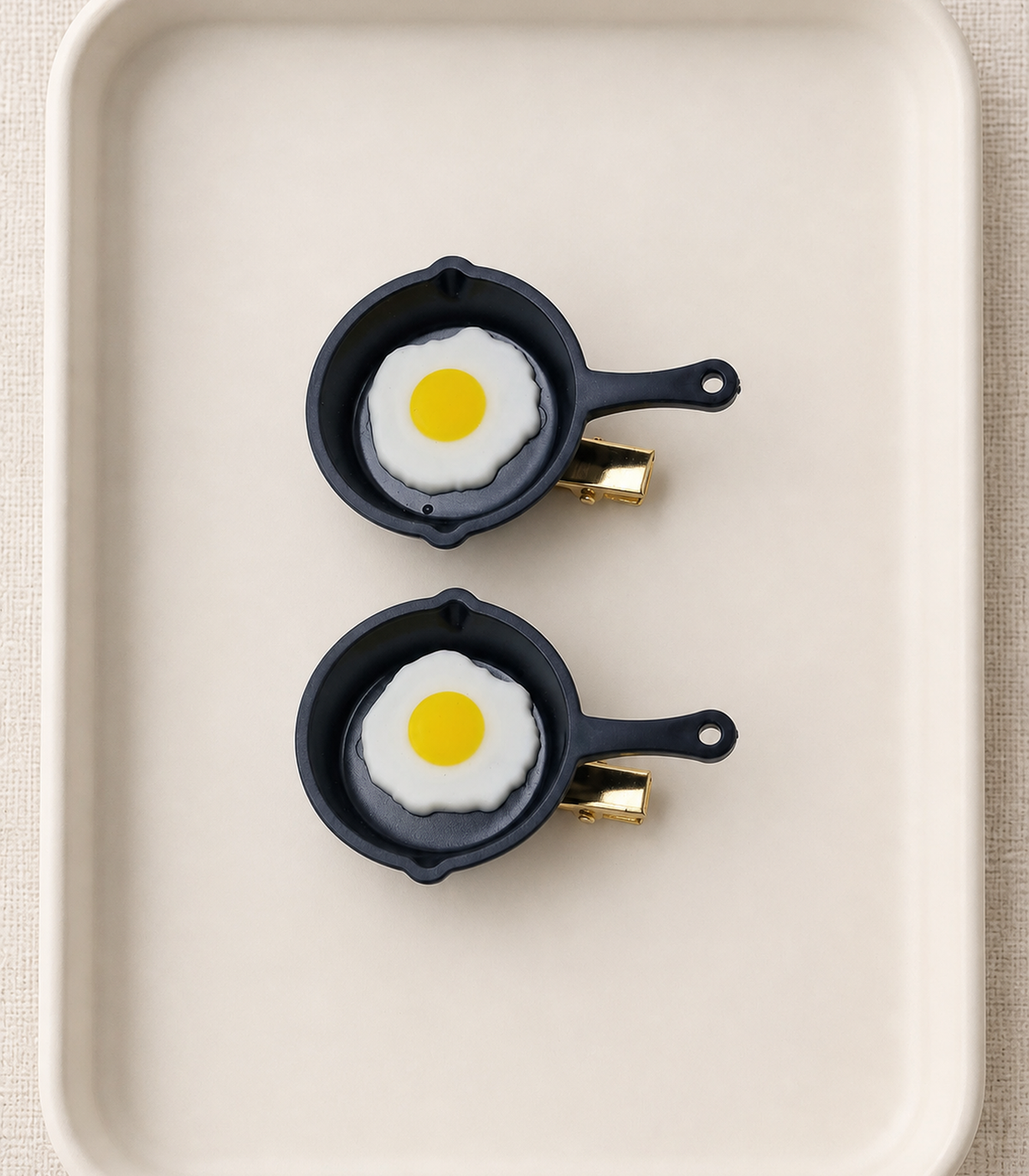 JIMIKI Sunny-Side-Up Egg Pan Barrette Pair in Black / White / Yellow, editorial flat lay