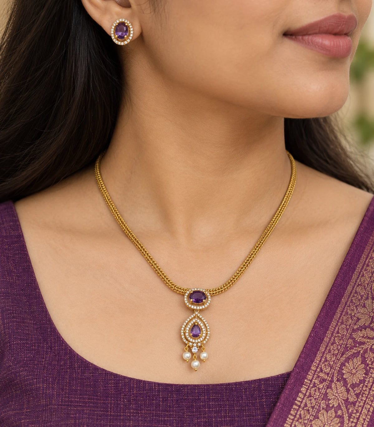 Close view of the purple oval and teardrop necklace pendant with three pearl-like drops and matching stud earring