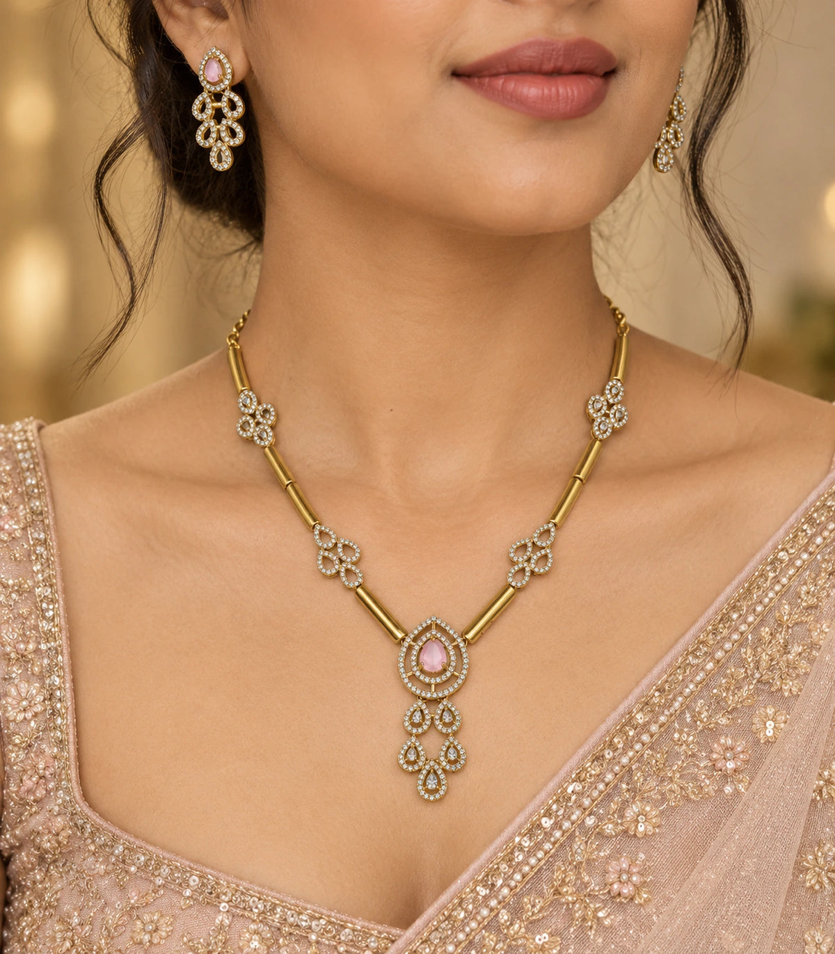 Gold-tone blush teardrop necklace set worn with a blush outfit