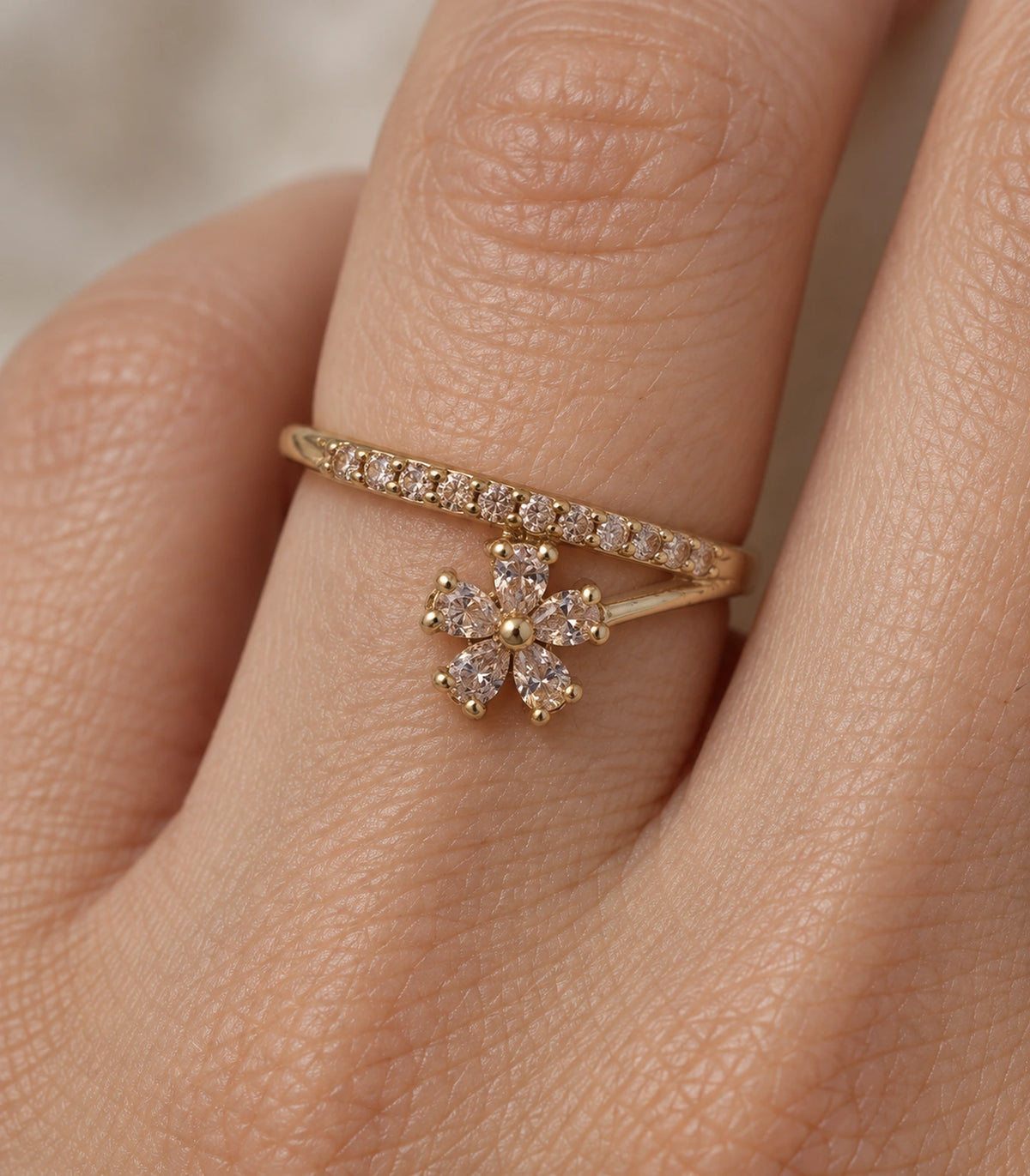 Gold Champagne Crystal Flower Sweep Ring — close-up of five-petal flower and stone-set sweep worn on finger
