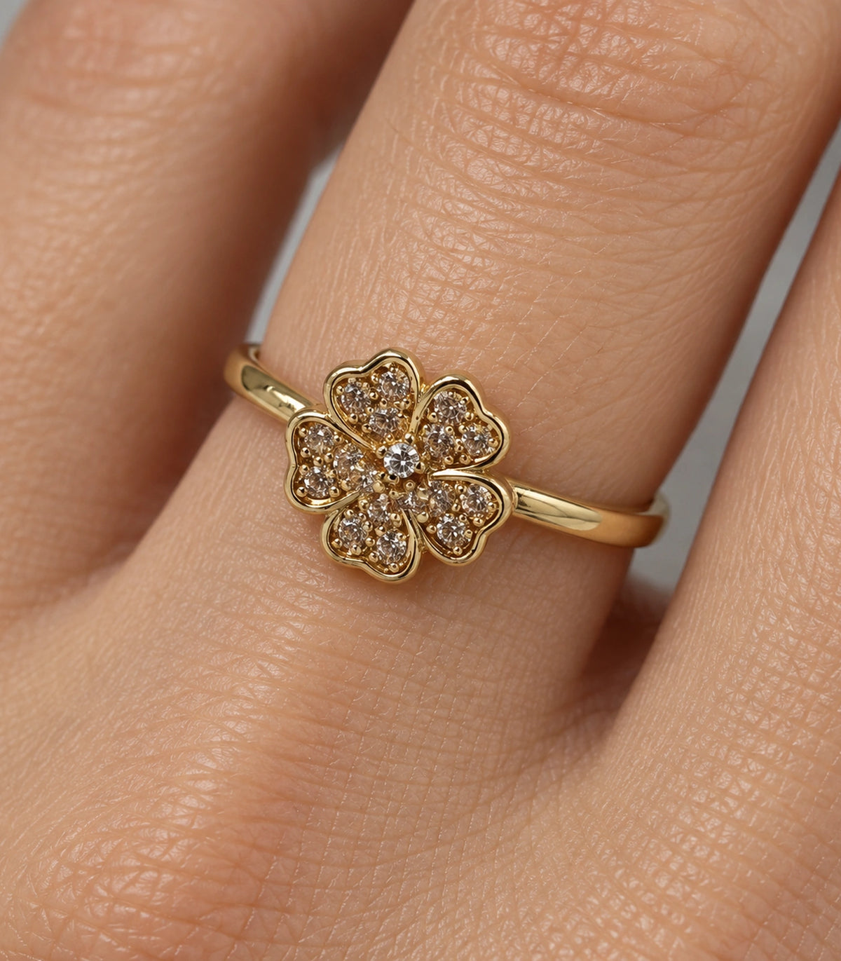 Close view of the gold-tone champagne crystal flower ring worn on a finger
