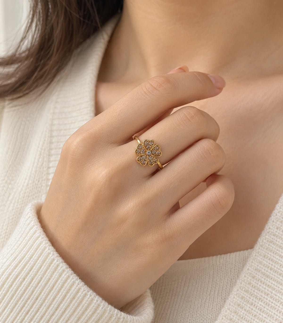 Gold-tone champagne crystal flower ring worn with a cream outfit