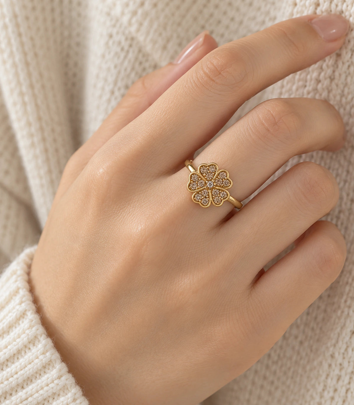 Gold-tone champagne crystal flower ring worn on a hand