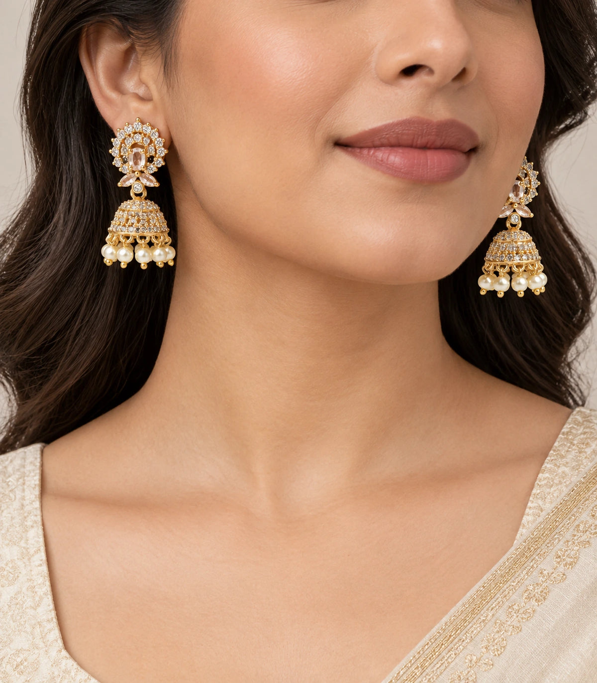 Gold-tone champagne and clear halo jhumka earrings worn with an ivory outfit