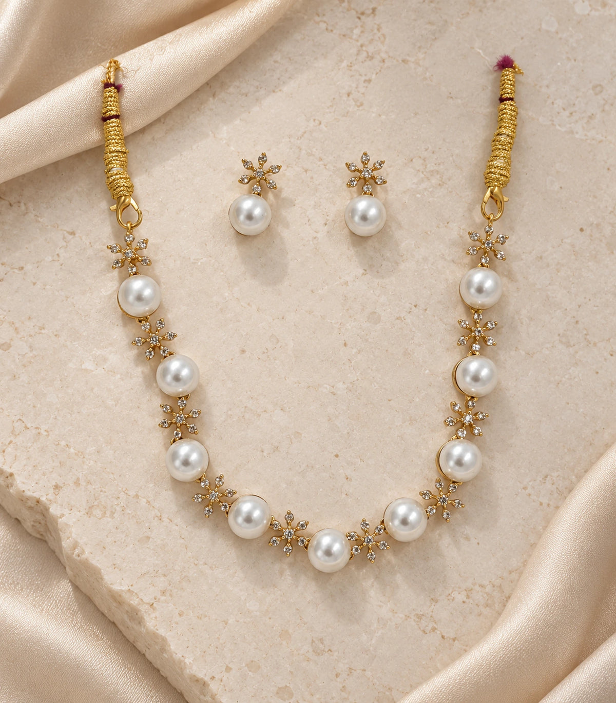 Gold Clear Floral Pearl Necklace Set with necklace and matching earrings arranged on a light surface