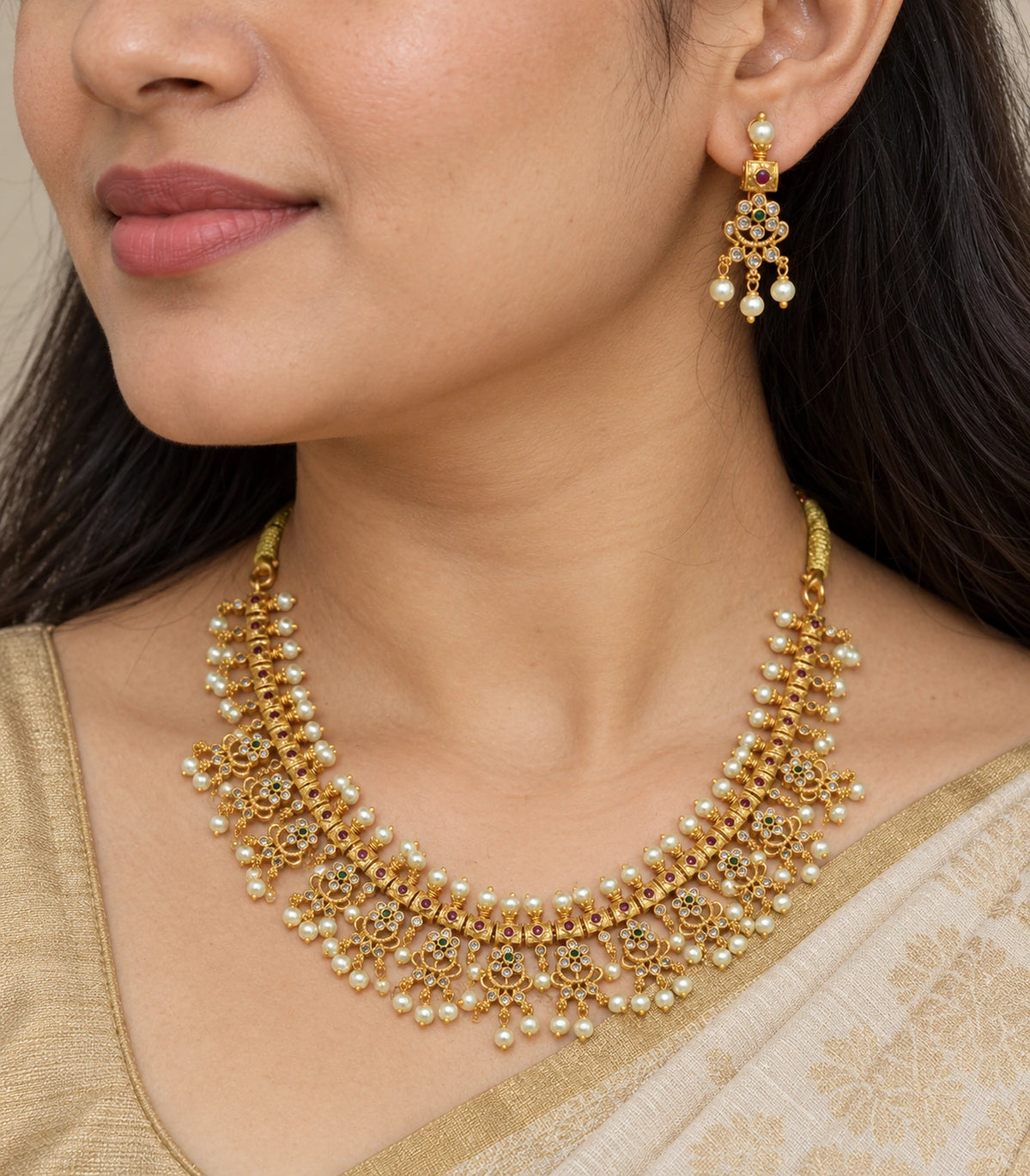 Close view of the Gold Clear Fringe Statement Necklace Set and one matching earring.