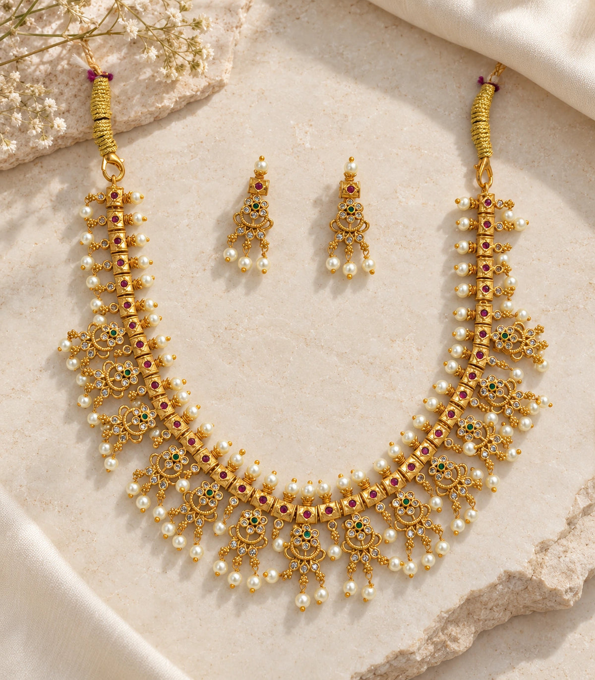 Gold Clear Fringe Statement Necklace Set: complete necklace and earring pair on a stone surface.