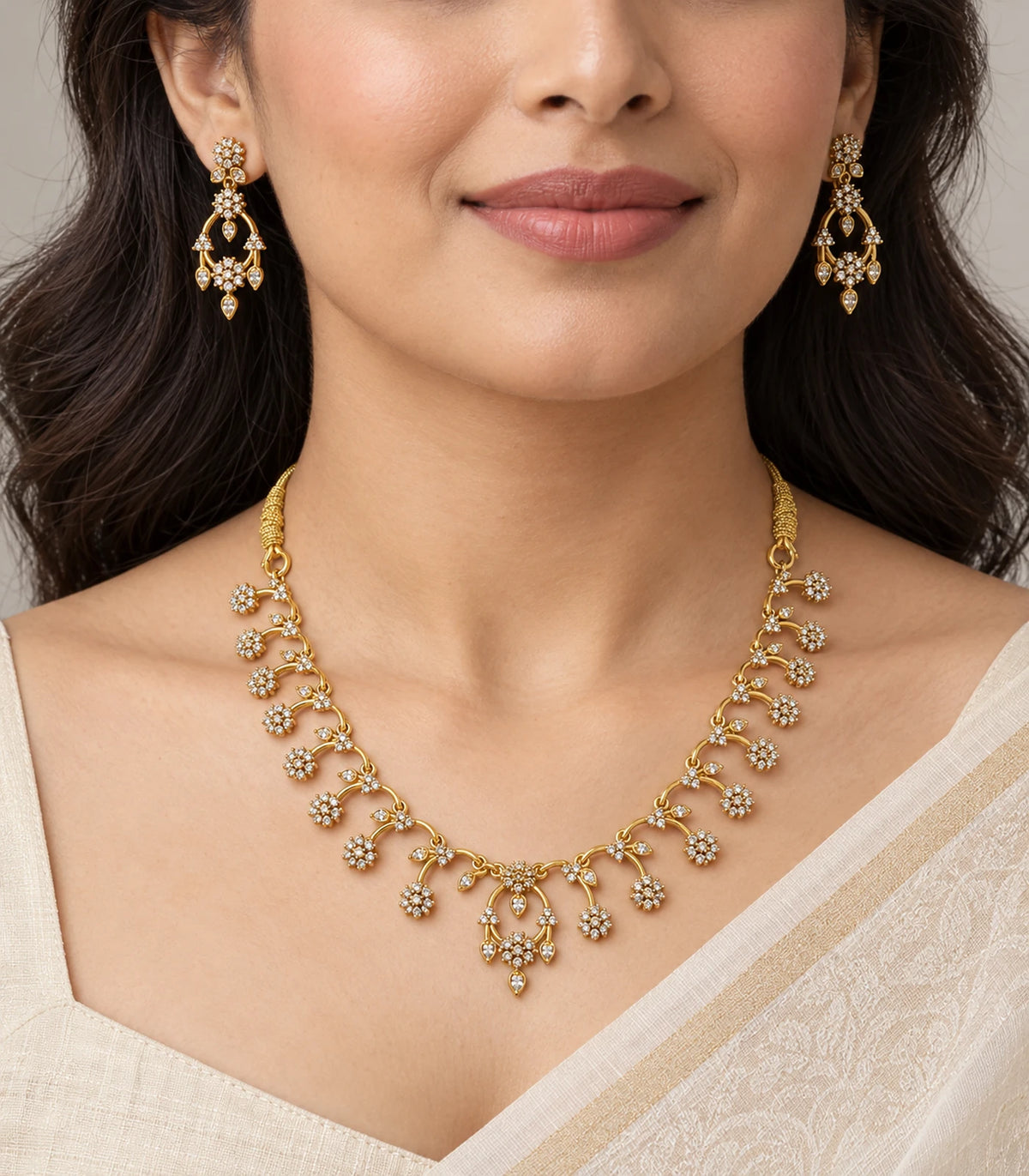 Gold-tone clear floral necklace set worn with an ivory outfit