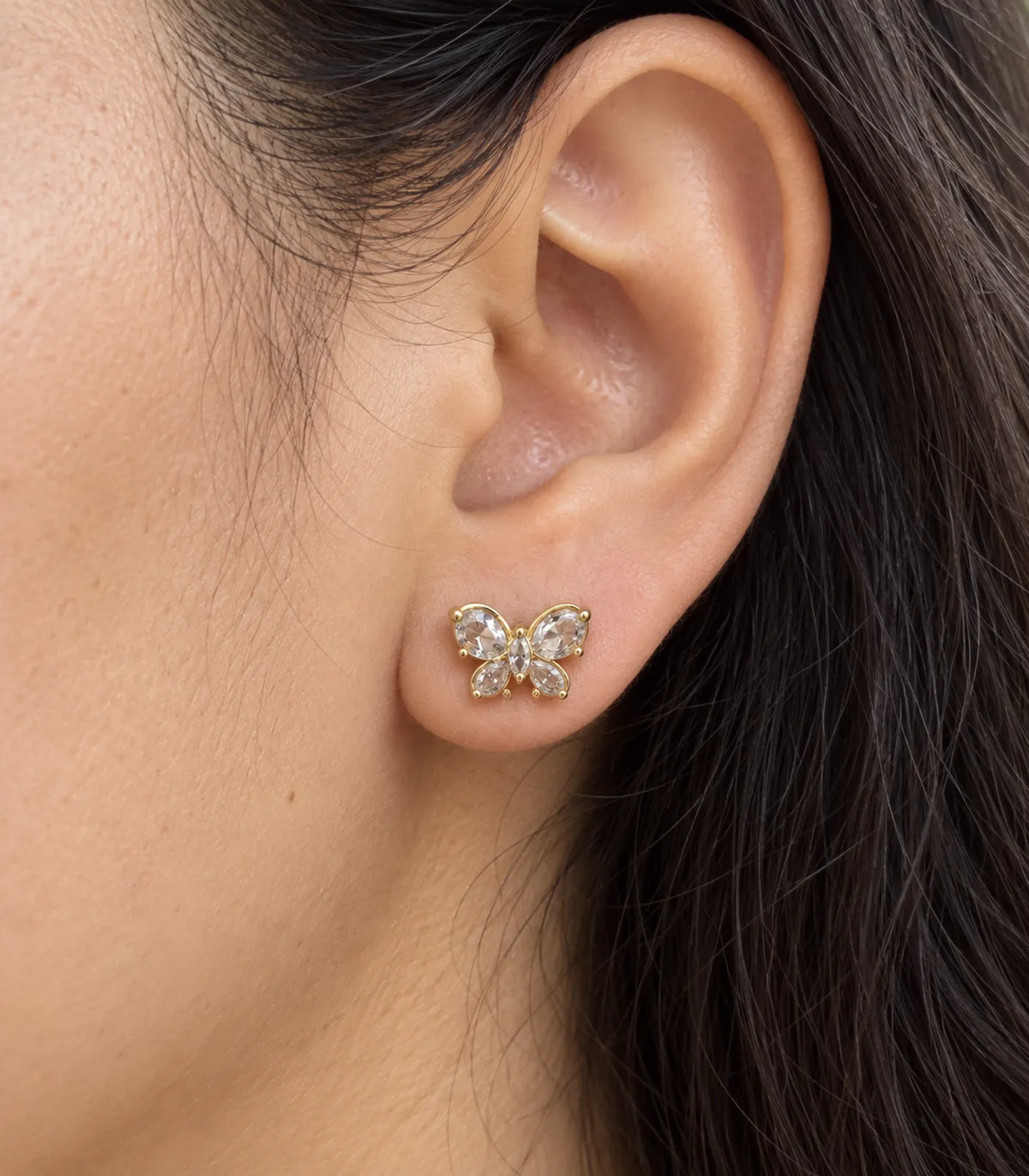 JIMIKI Gold Crystal Butterfly Stud Earrings — worn close-up detail #color_gold-tone